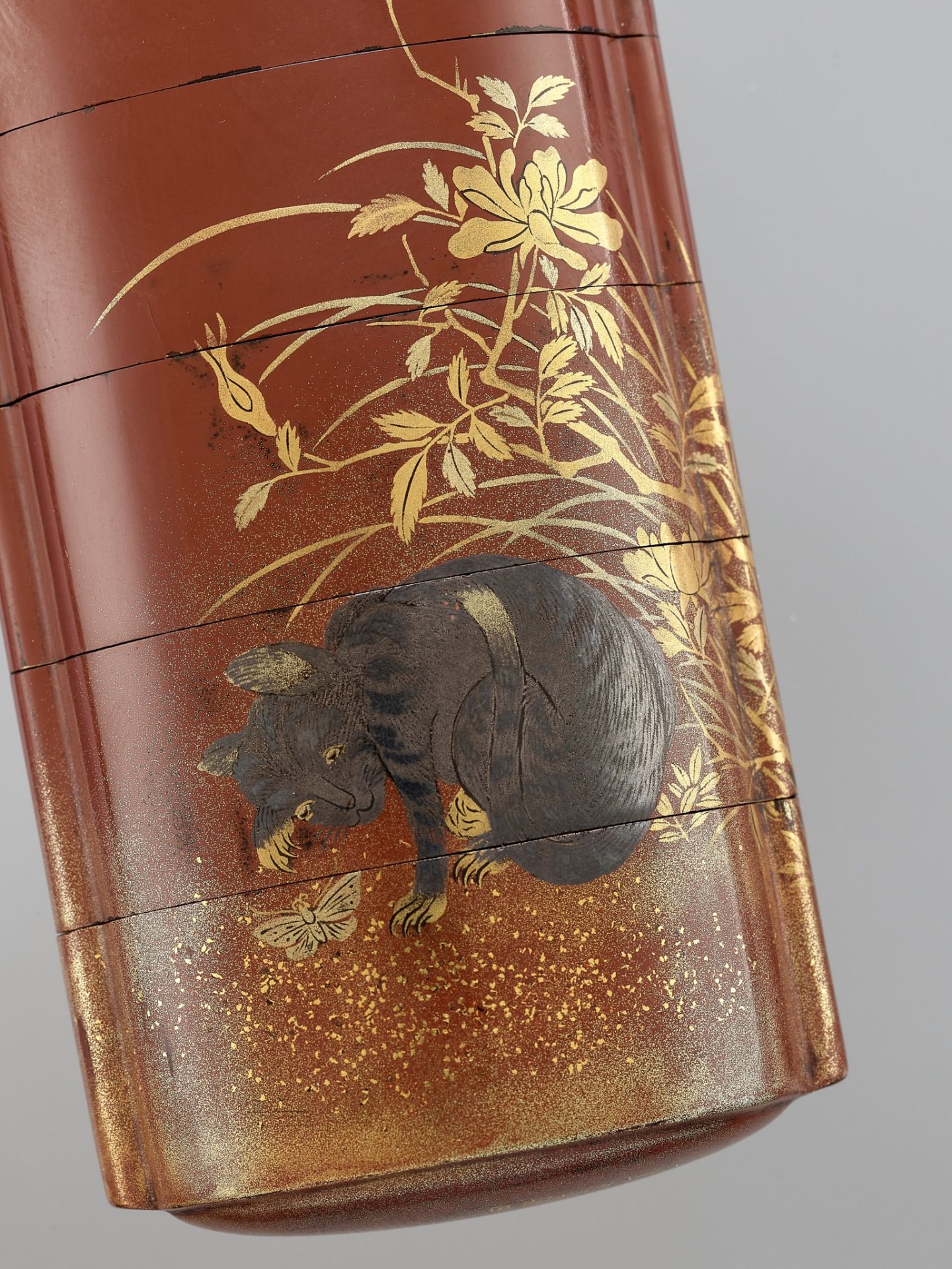 TATSUKE KOKOSAI: A RARE LACQUER FOUR-CASE INRO DEPICTING A CAT AND BUTTERFLY