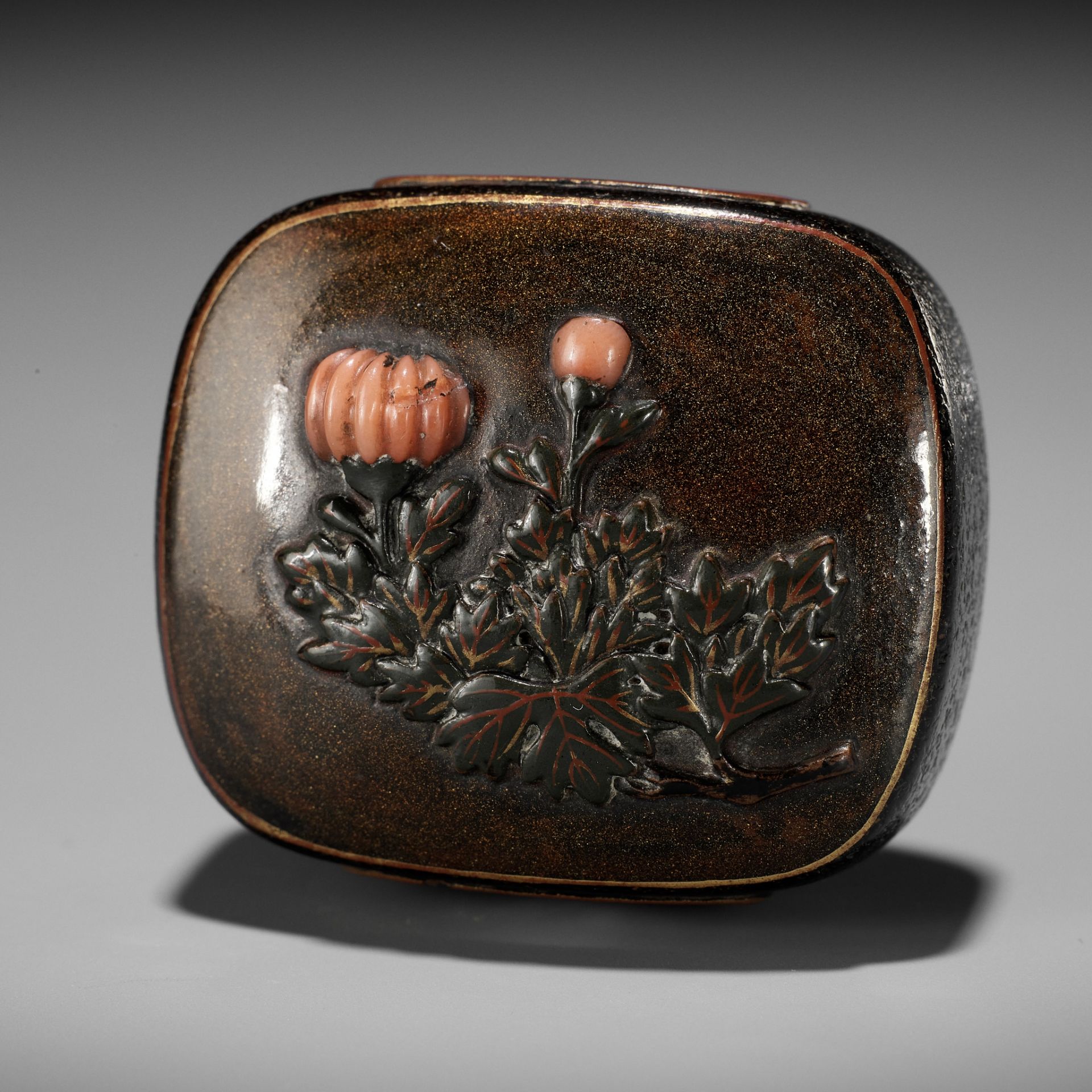 A RARE AND UNUSUAL LACQUER NETSUKE WITH FLORAL DESIGN