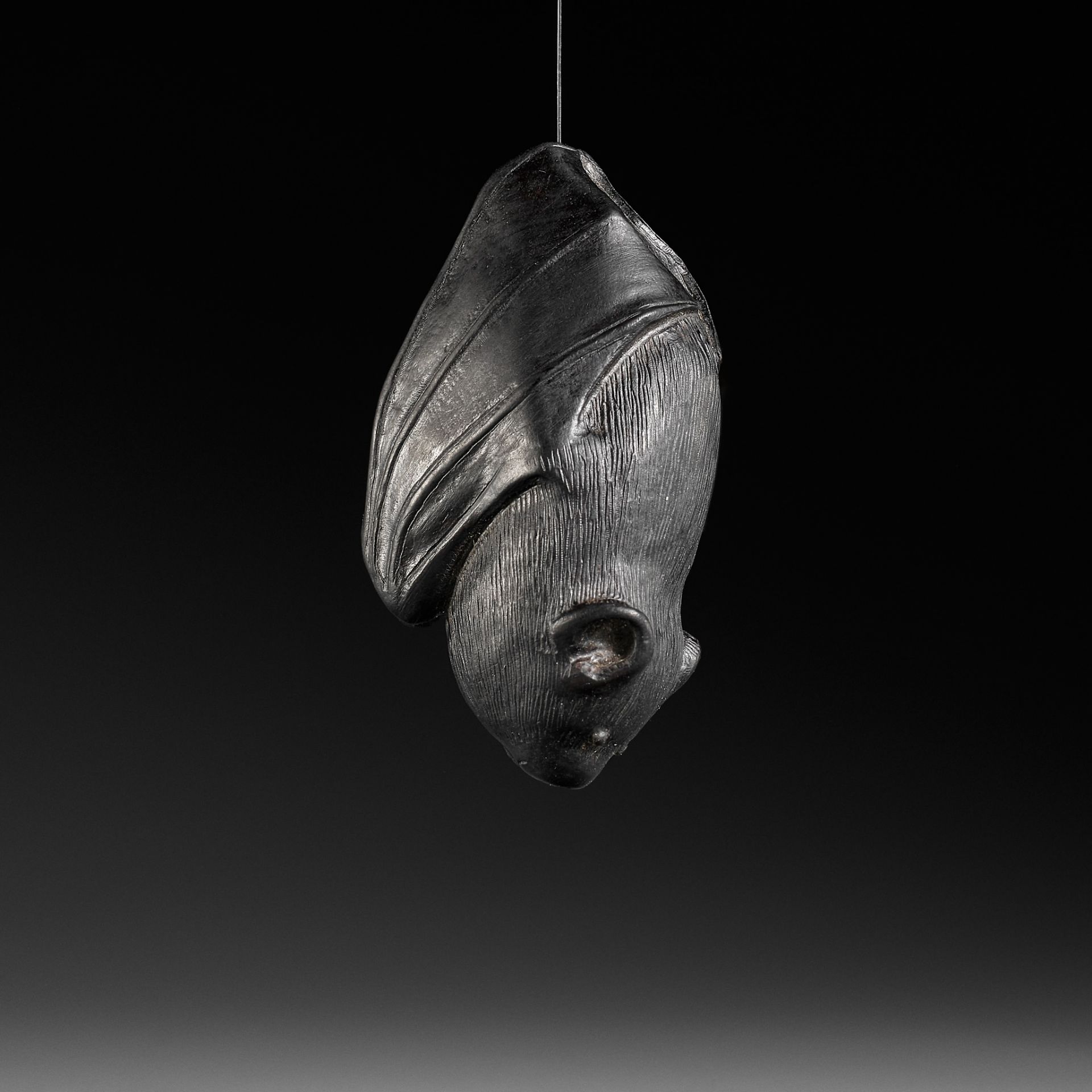 A RARE EBONY NETSUKE OF A BAT