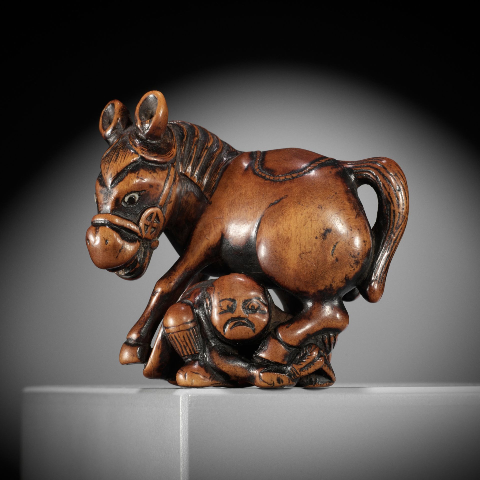 A SUPERB WOOD NETSUKE OF A MULE AND GROOM