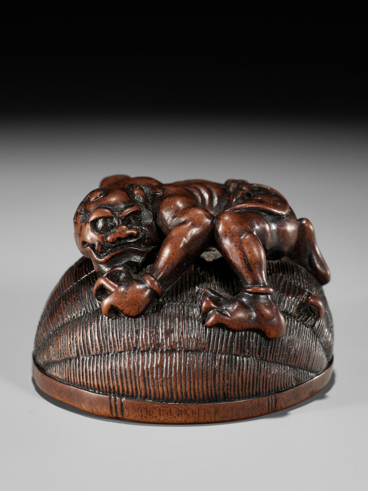 MASANAO: A RARE WOOD NETSUKE OF AN ONI TRAPPING SHOKI - Image 7 of 14