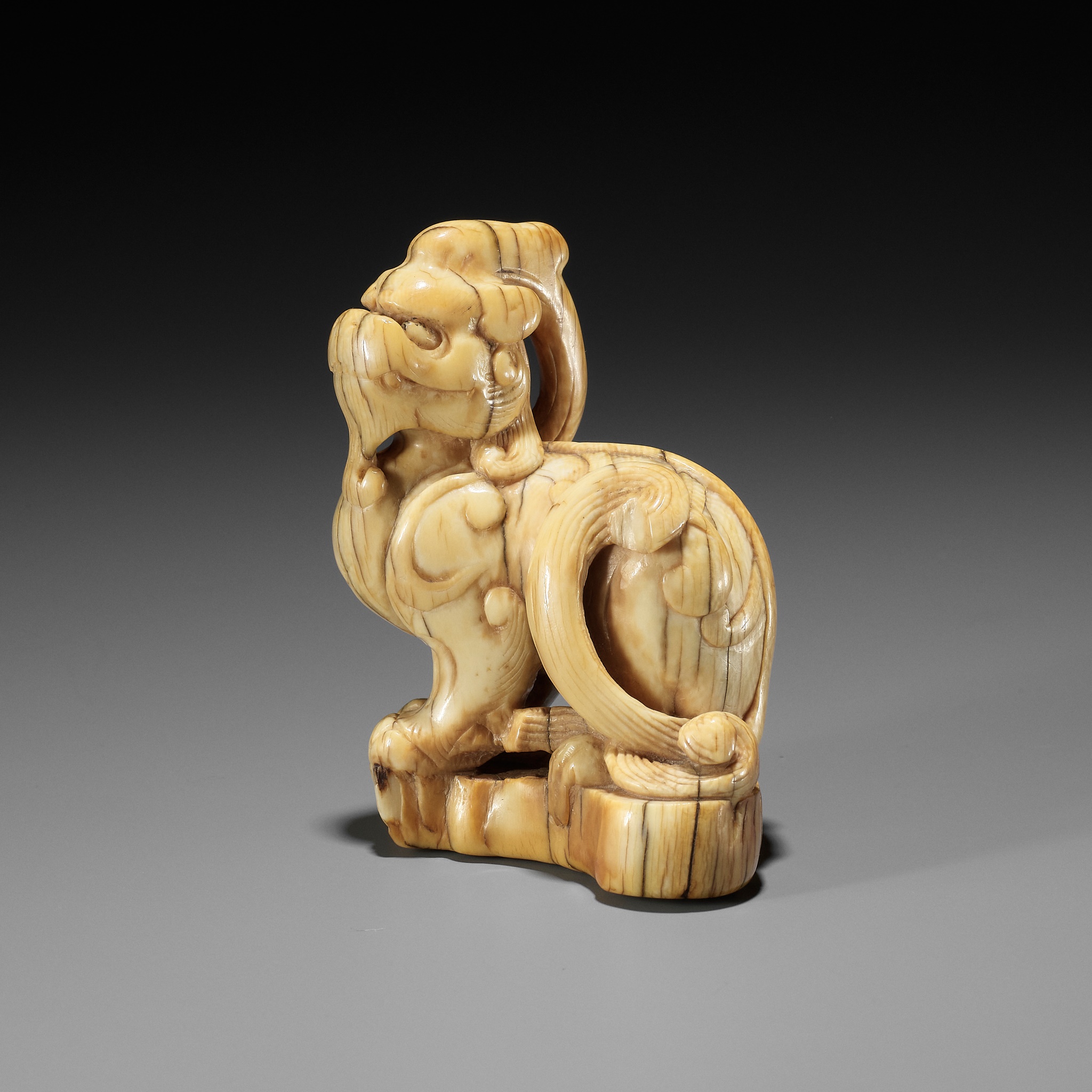 A LARGE AND RARE IVORY TOBORI NETSUKE OF A MYTHICAL BEAST