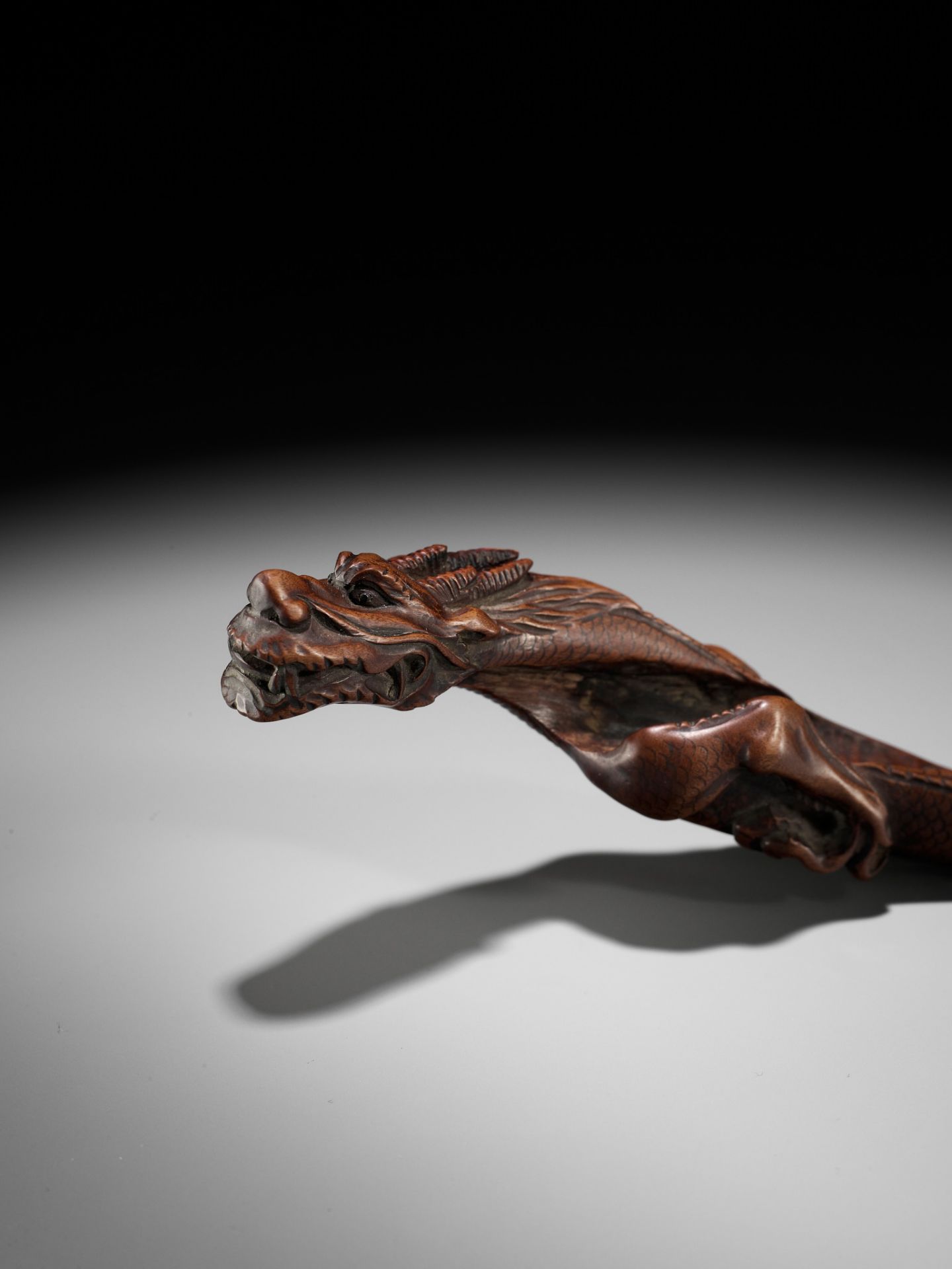 A RARE WOOD KISERUZUTSU DEPICTING A SINIOUS DRAGON