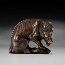 A SUPERB TOYOMASA SCHOOL WOOD NETSUKE OF AN EMACIATED WOLF WITH TORTOISE