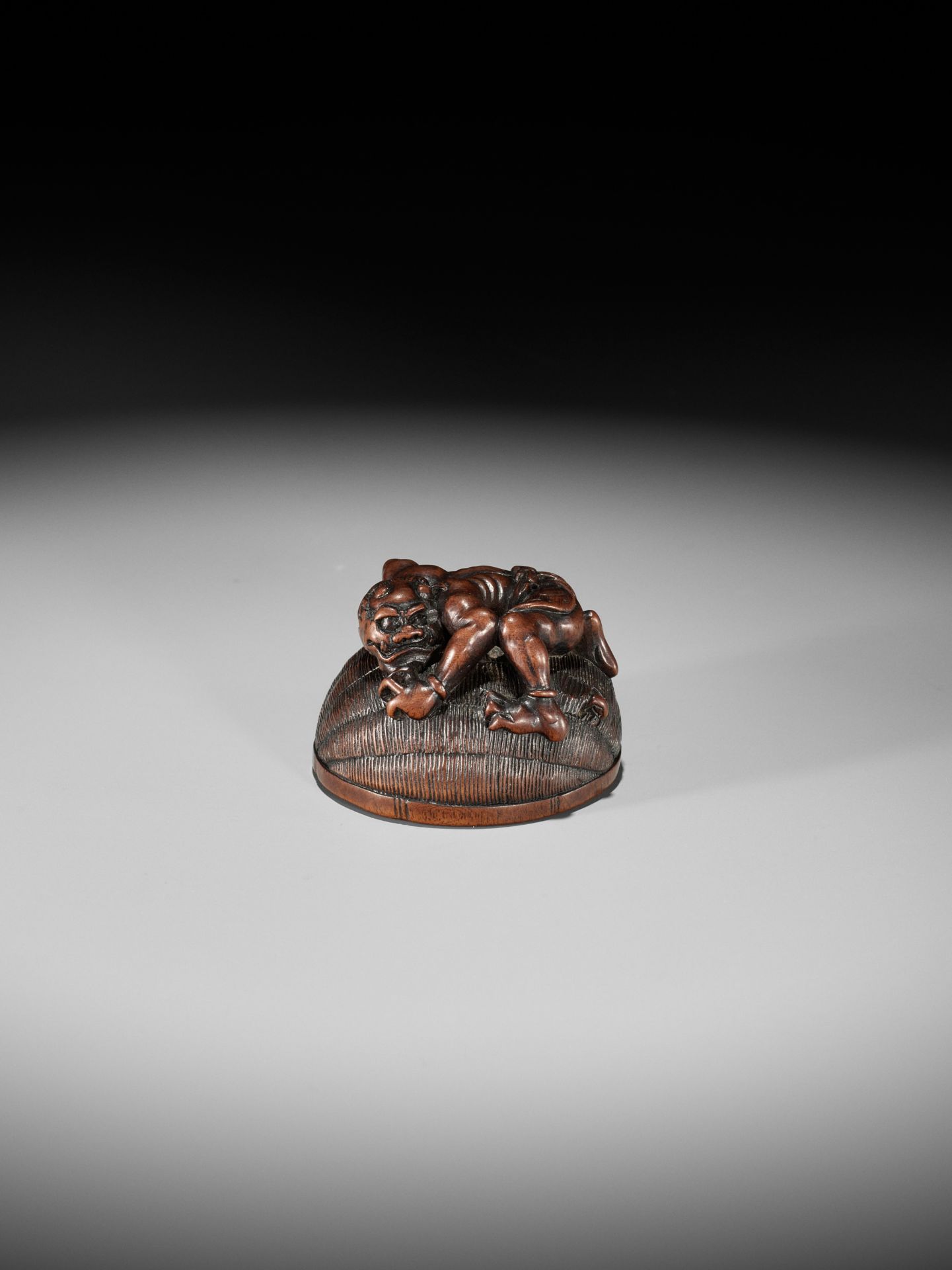 MASANAO: A RARE WOOD NETSUKE OF AN ONI TRAPPING SHOKI - Image 9 of 14