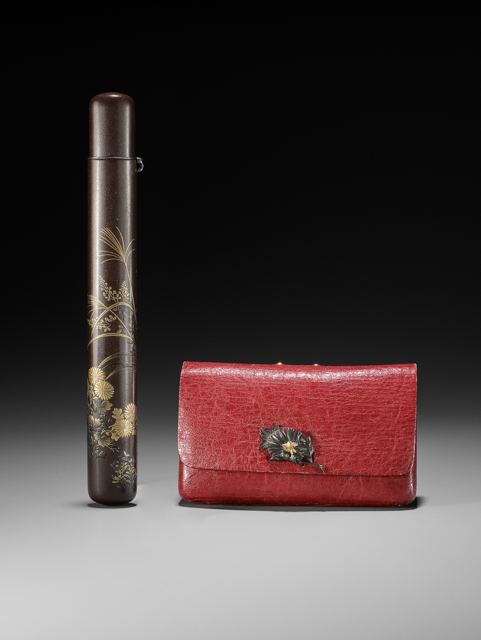 A LACQUER KISERUZUTSU AND A RED LEATHER POUCH DEPICTING AUTUMN GRASSES AND FLOWERS