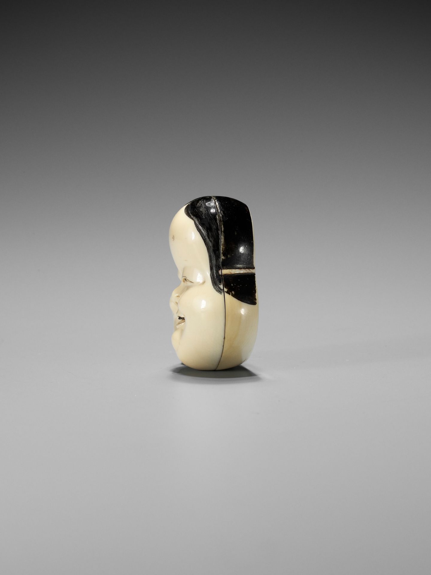YOZEI: A RARE LACQUERED IVORY HAKO (BOX) AND COVER IN THE FORM OF AN OKAME MASK, DATED 1705 - Image 7 of 10