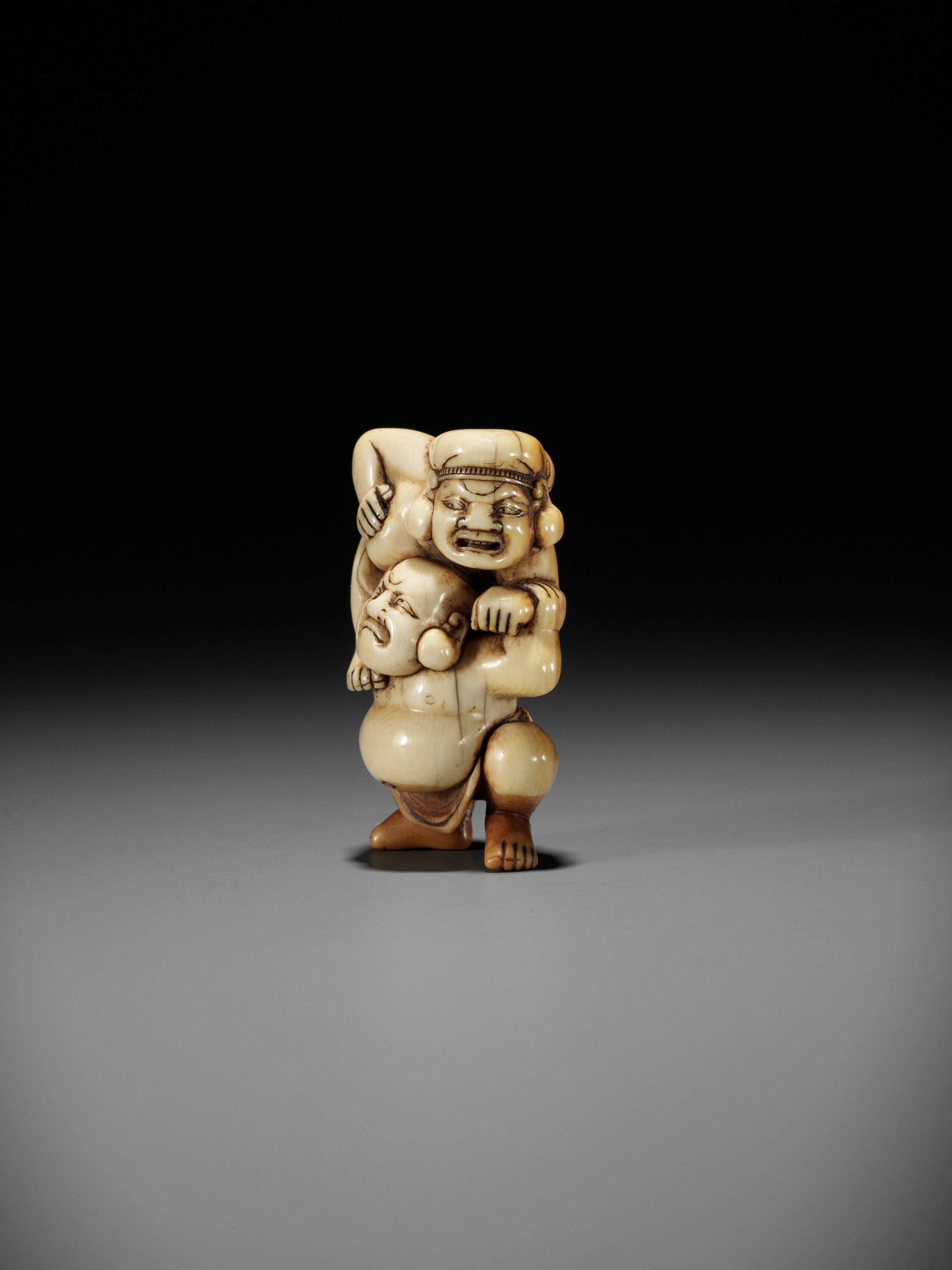 AN IVORY NETSUKE OF HOTEI AND DAIKOKU WRESTLING - Image 6 of 13