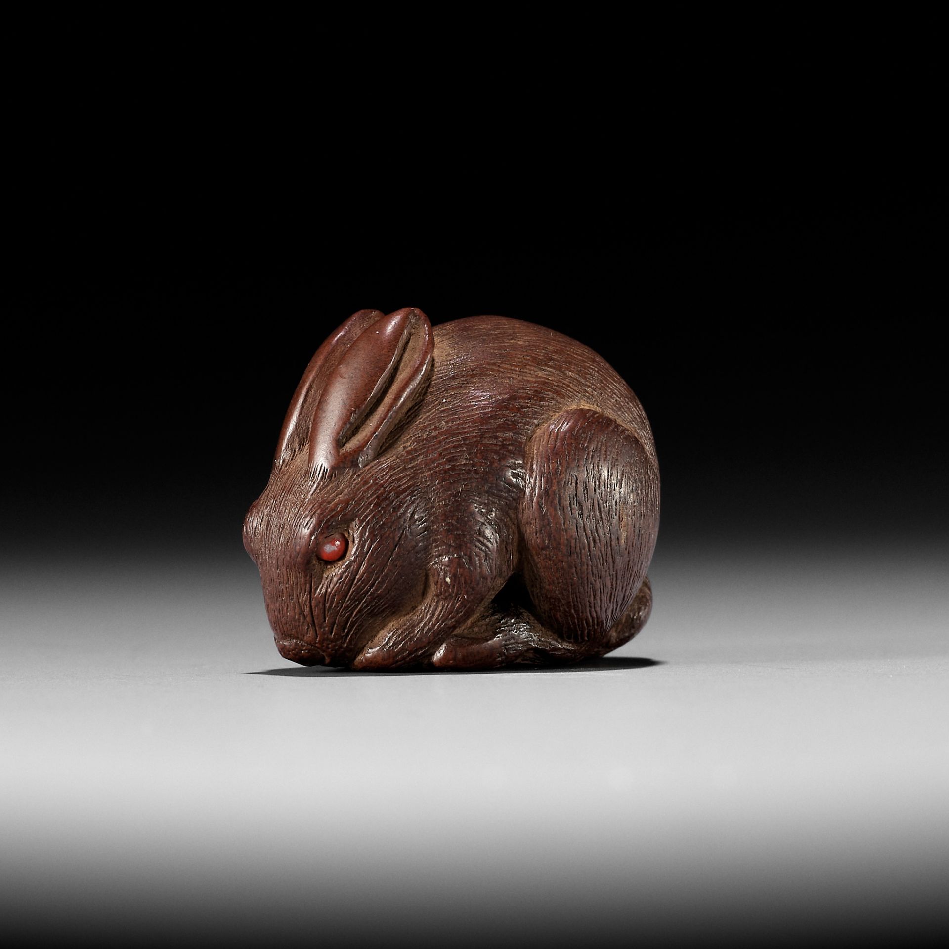 KOKEI: A FINE AND RARE WOOD NETSUKE OF A HARE