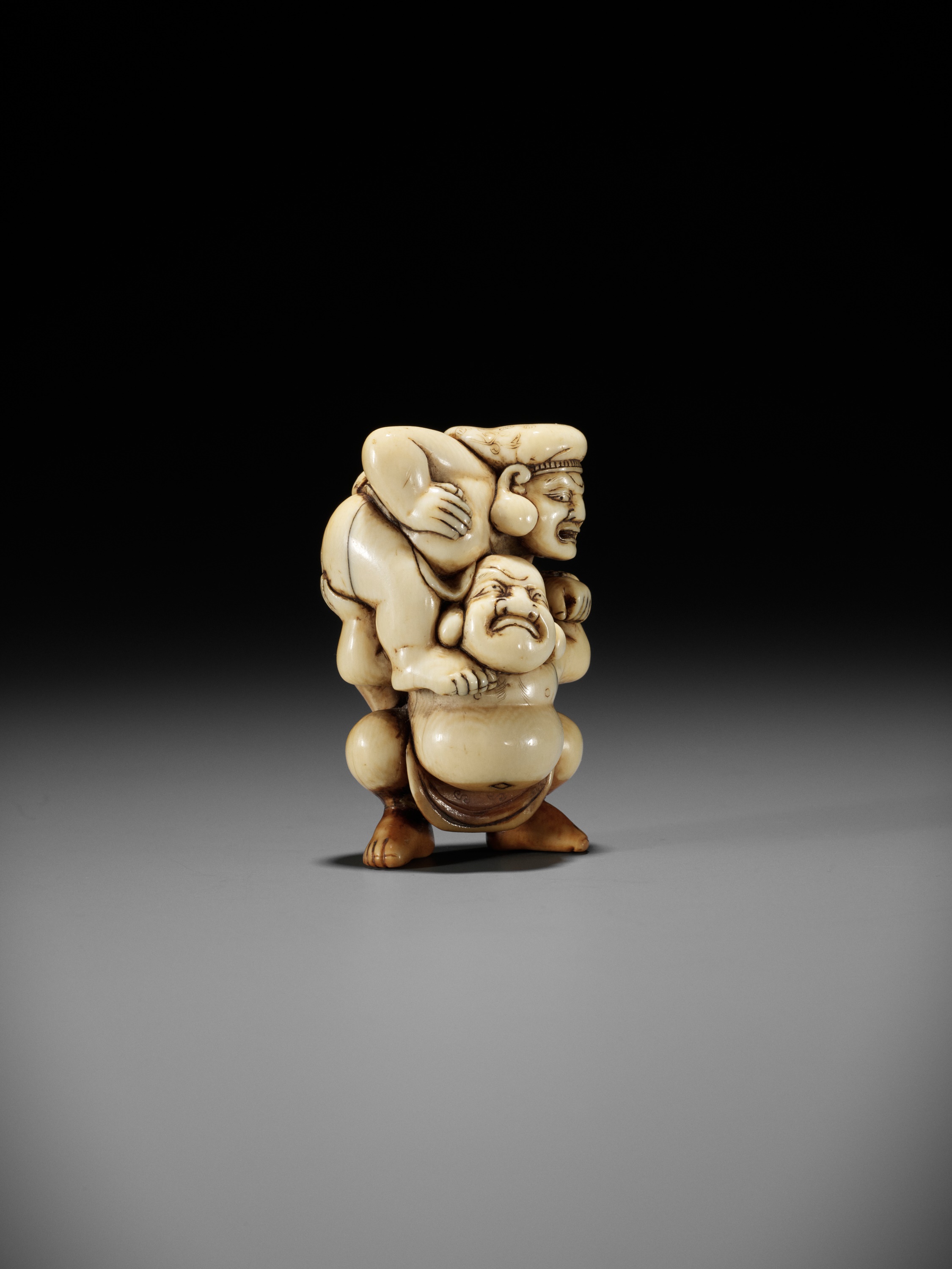 AN IVORY NETSUKE OF HOTEI AND DAIKOKU WRESTLING - Image 9 of 13