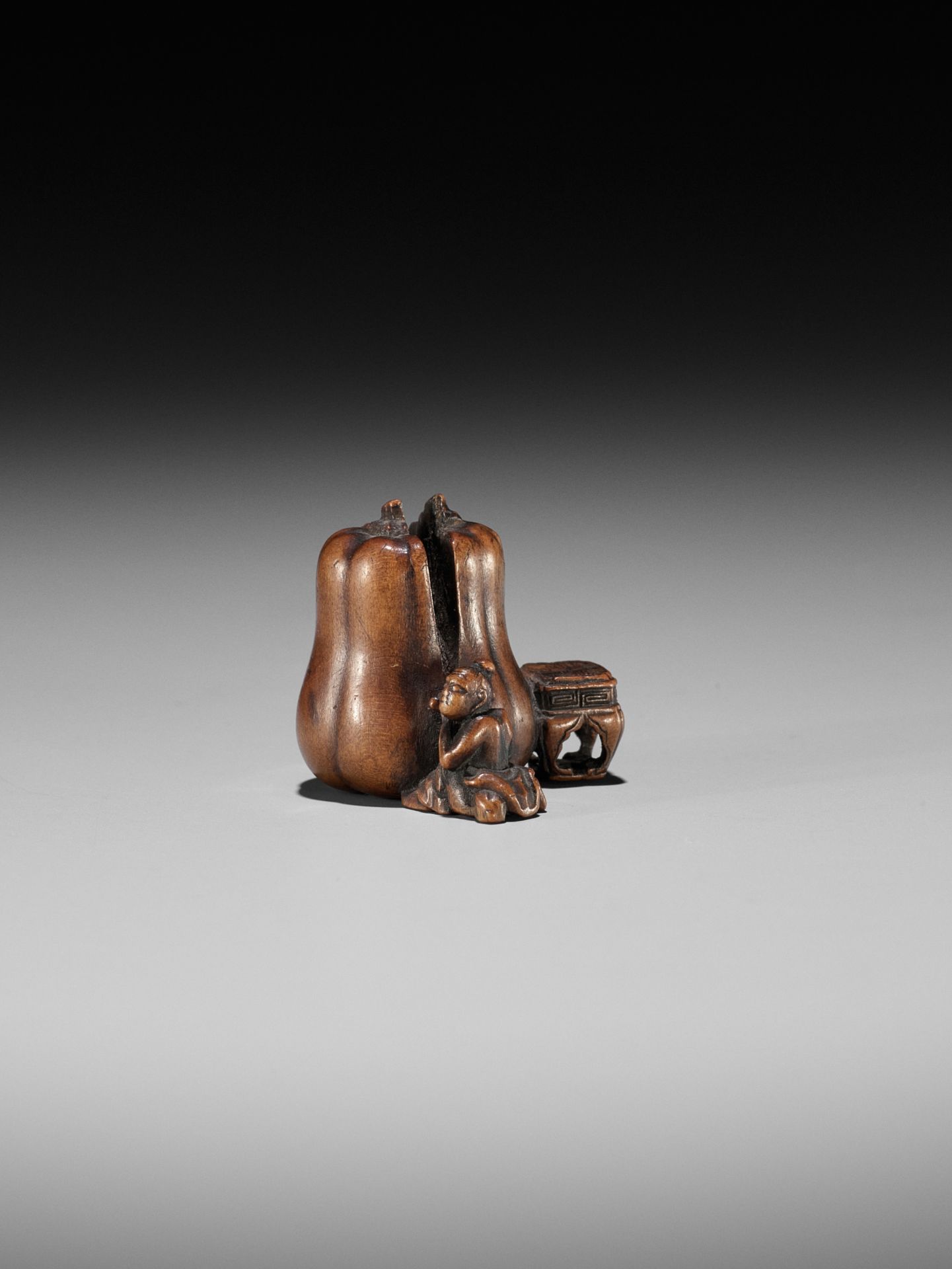 NAOYUKI: AN EXQUISITE MINIATURE WOOD NETSUKE OF A NIO CUTTING THROUGH A GIGANTIC GOURD - Image 3 of 9