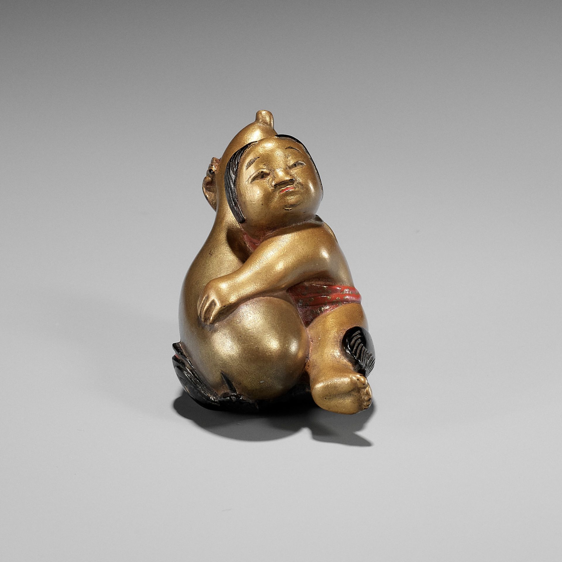 A RARE GOLD LACQUER NETSUKE OF A GOSHO NINGYO DOLL AS KADORI MYOJIN