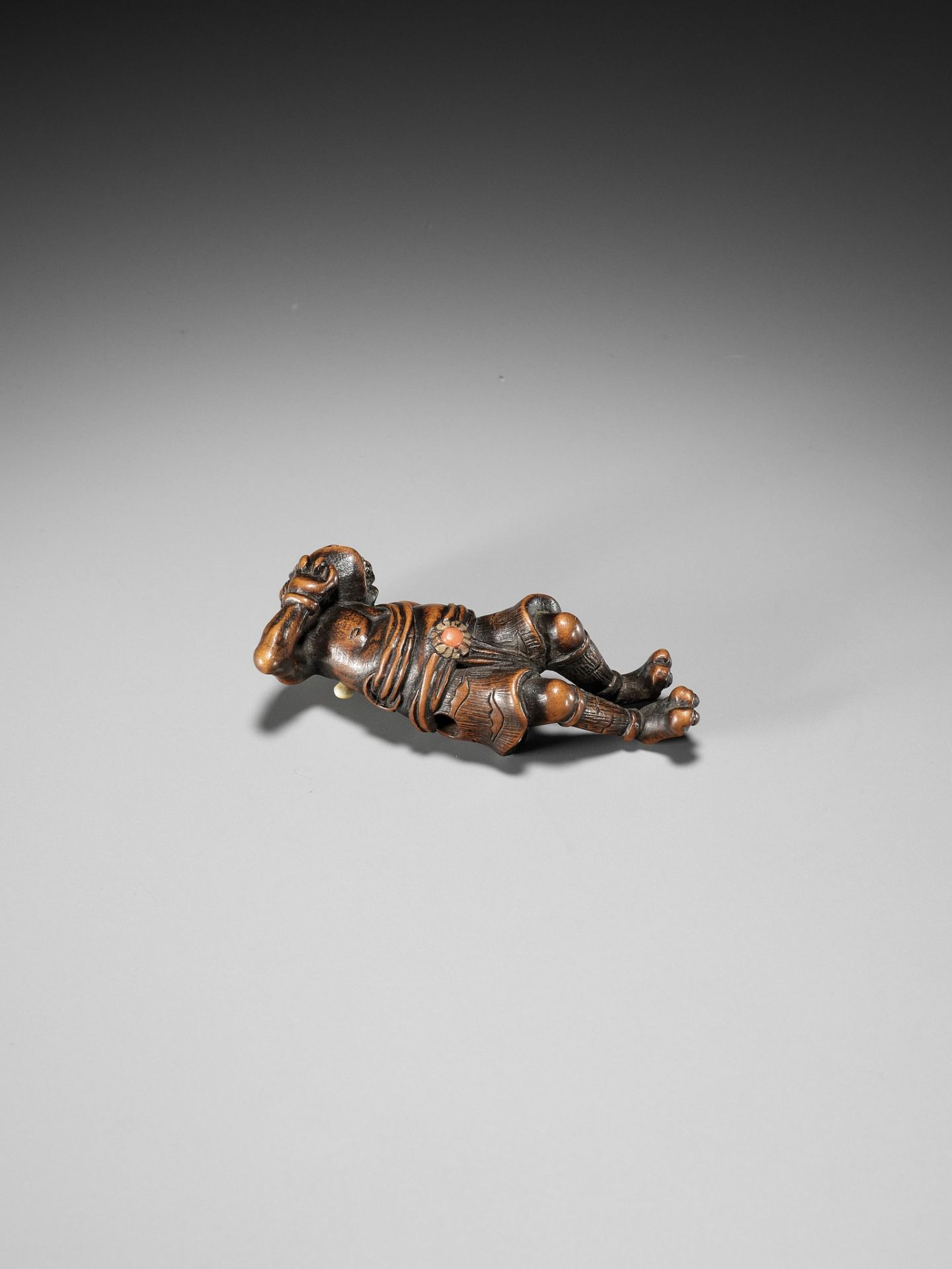 AN INLAID WOOD NETSUKE OF A RECLINING ONI AT SETSUBUN - Image 9 of 10