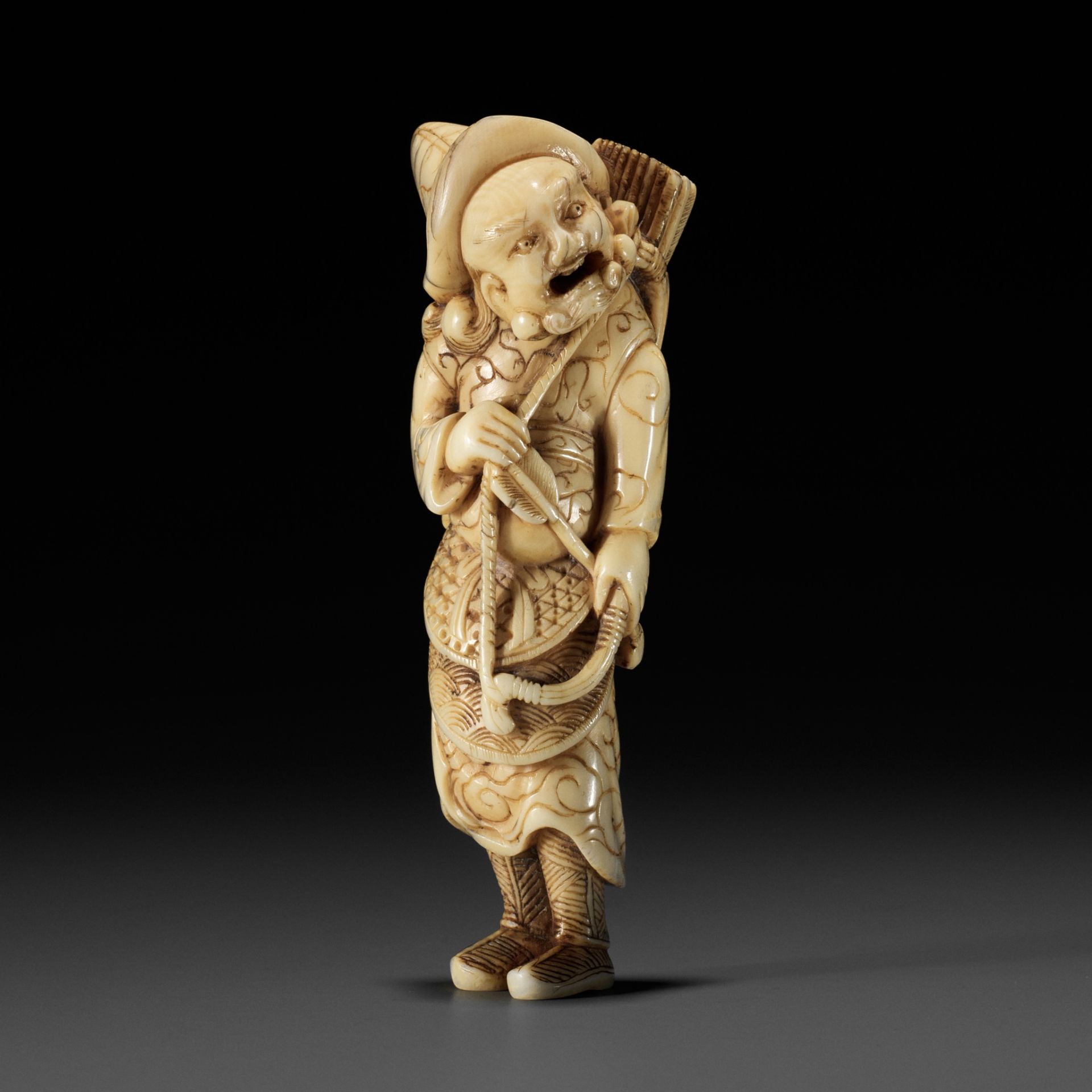 A POWERFUL TALL IVORY NETSUKE OF A TARTAR ARCHER