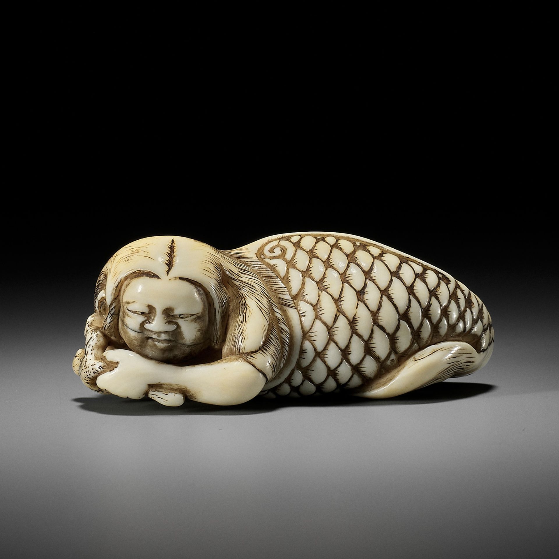 A VERY RARE IVORY NETSUKE OF A MERMAN