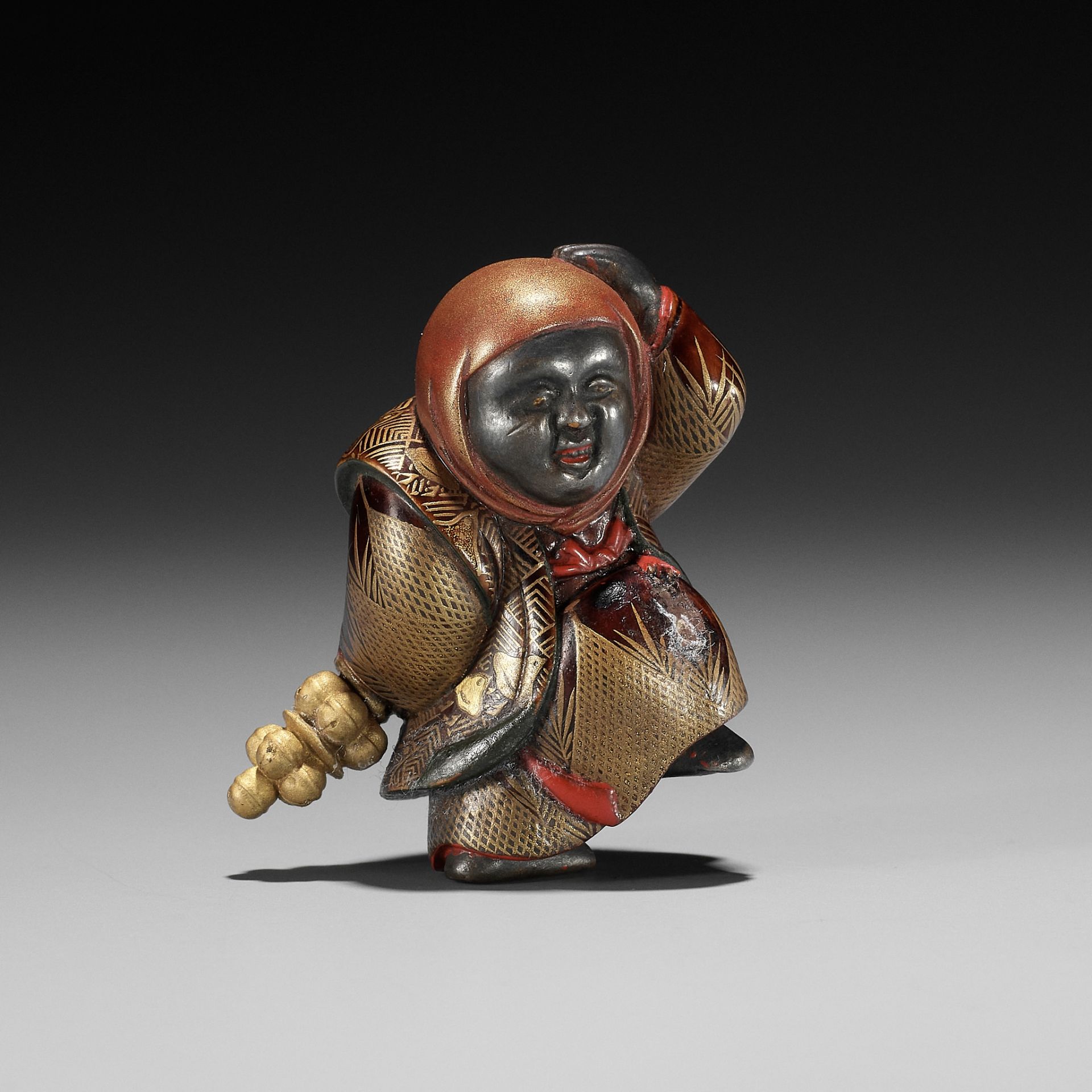 A RARE LACQUER NETSUKE OF A GOSHO NINGYO DOLL PERFORMER