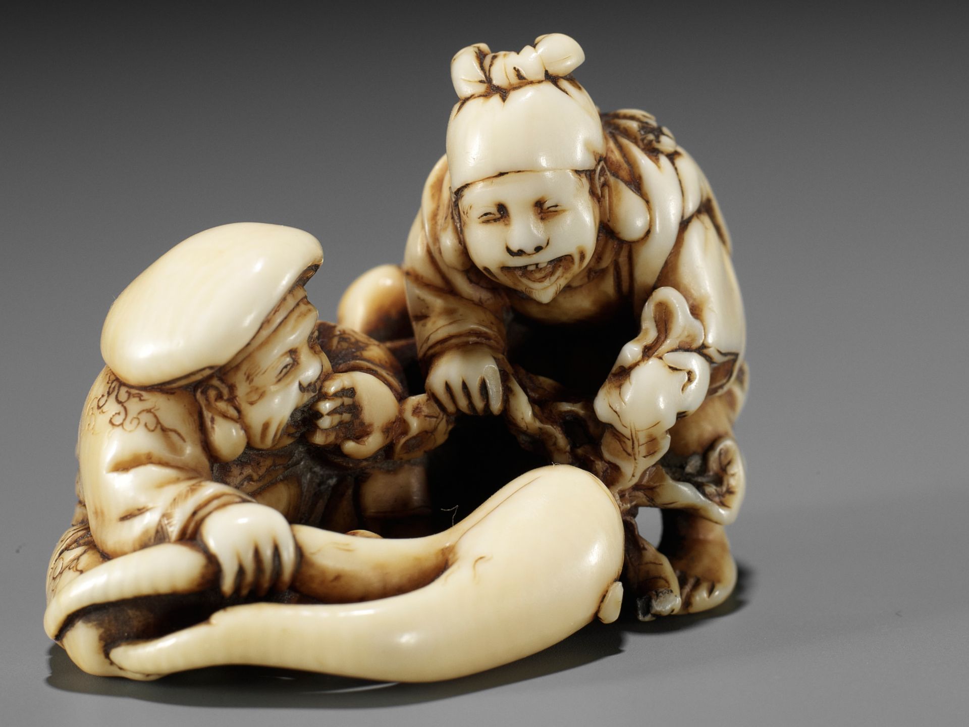 IKKOSAI: AN AMUSING IVORY SHUNGA NETSUKE OF DAIKOKU AND EBISU