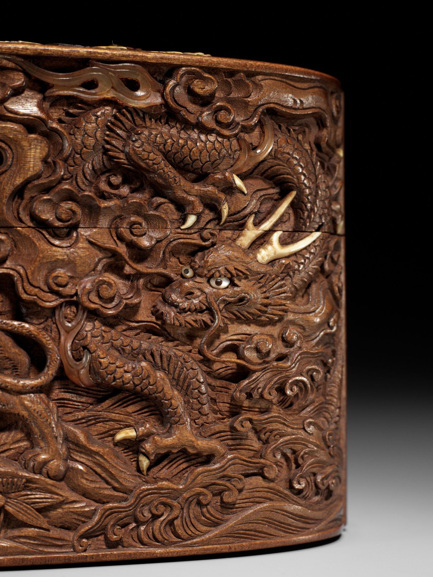 A LARGE AND FINE INLAID AND CARVED WOOD TONKOTSU WITH DRAGON, TIGER AND SHISHI