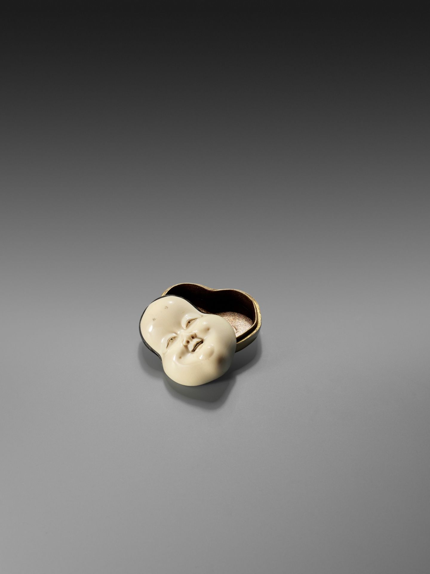 YOZEI: A RARE LACQUERED IVORY HAKO (BOX) AND COVER IN THE FORM OF AN OKAME MASK, DATED 1705 - Image 5 of 10