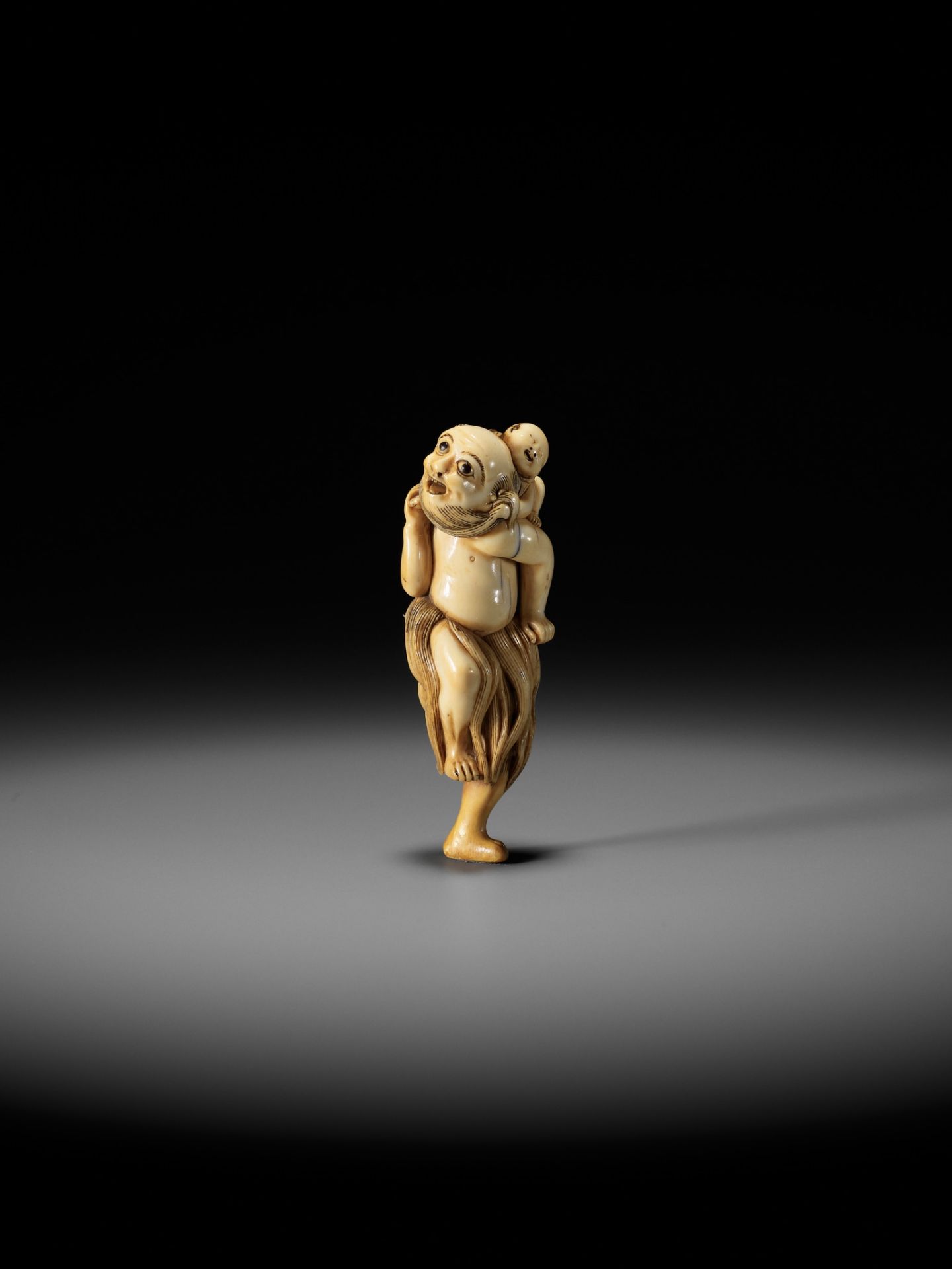 A SUPERB IVORY NETSUKE OF A FISHERMAN CARRYING A BOY, ATTRIBUTED TO GECHU - Image 2 of 12