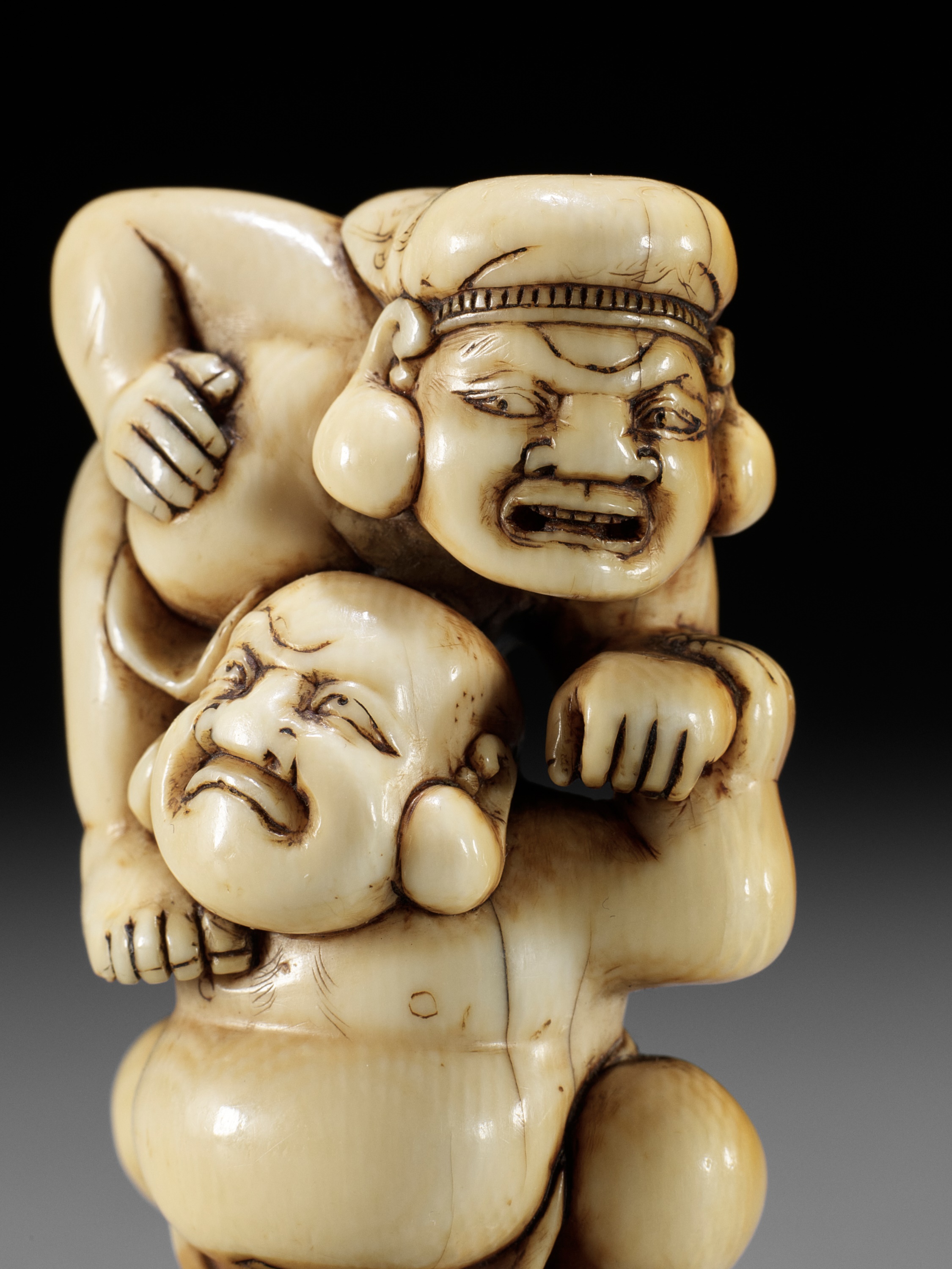 AN IVORY NETSUKE OF HOTEI AND DAIKOKU WRESTLING - Image 10 of 13