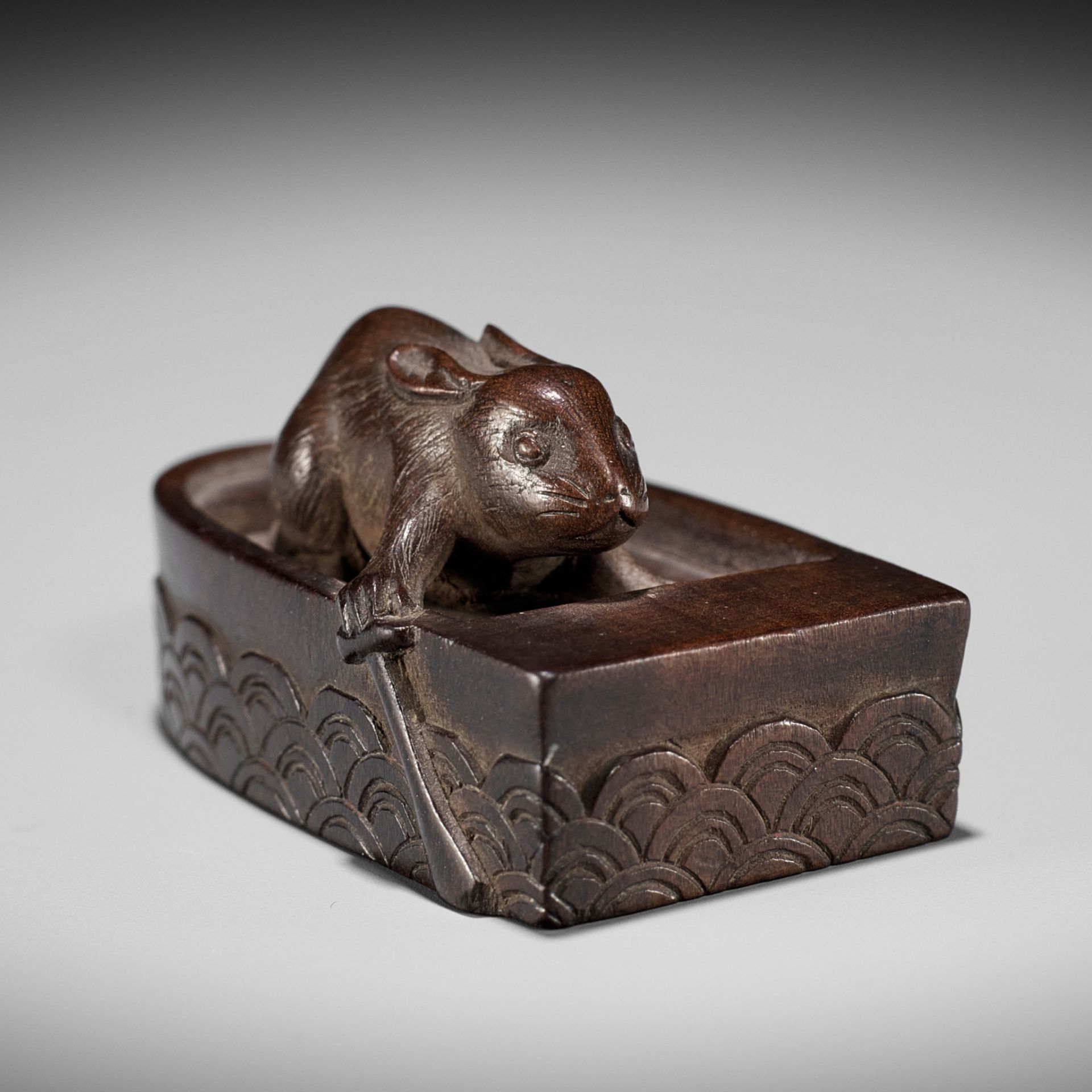 JUJO: A FINE WOOD NETSUKE OF HARE IN BOAT, KACHI-KACHI YAMA