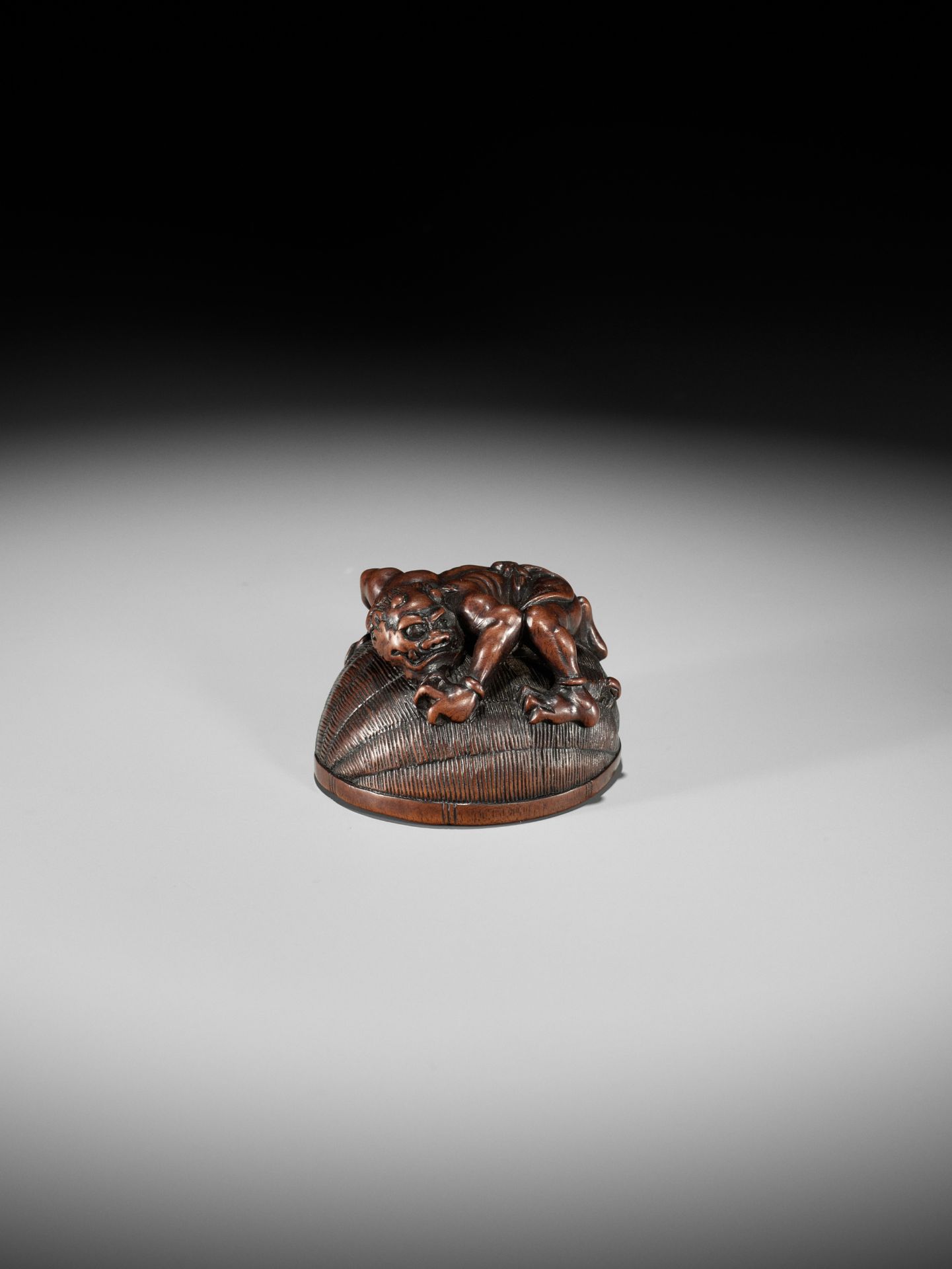 MASANAO: A RARE WOOD NETSUKE OF AN ONI TRAPPING SHOKI - Image 3 of 14