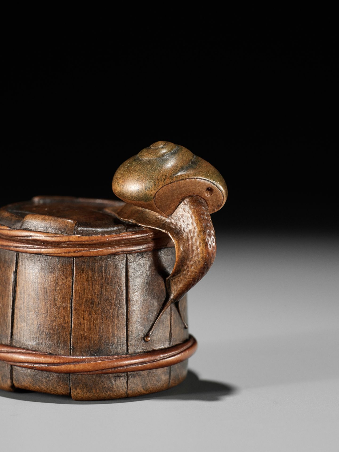 SHIGEMASA: A FINE WOOD NETSUKE OF A SNAIL ON BUCKET