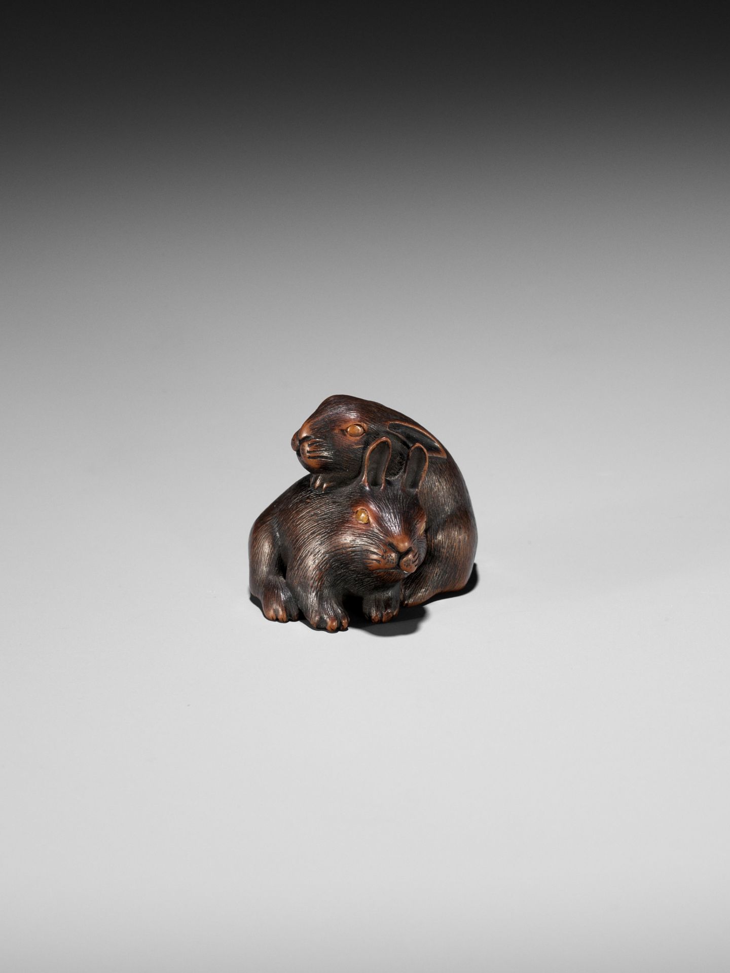 MASATADA: A FINE WOOD NETSUKE OF TWO RABBITS WITH AMBER EYES - Image 3 of 11