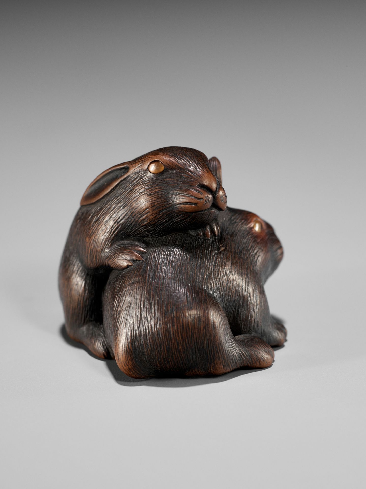 MASATADA: A FINE WOOD NETSUKE OF TWO RABBITS WITH AMBER EYES - Image 2 of 11