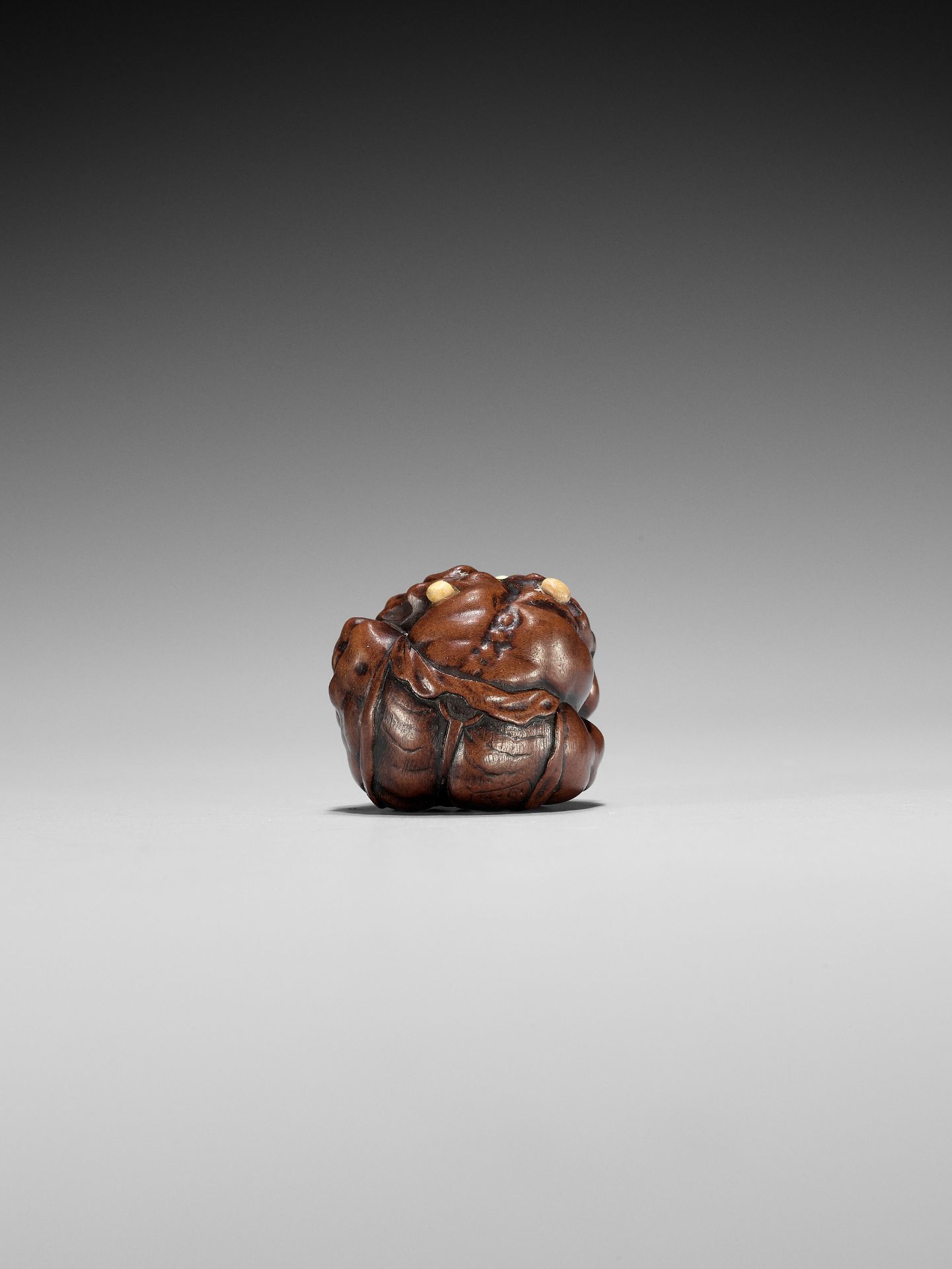 MASATOSHI: A FINE NAGOYA SCHOOL WOOD NETSUKE OF A COWERING ONI DURING SETSUBUN - Image 3 of 10