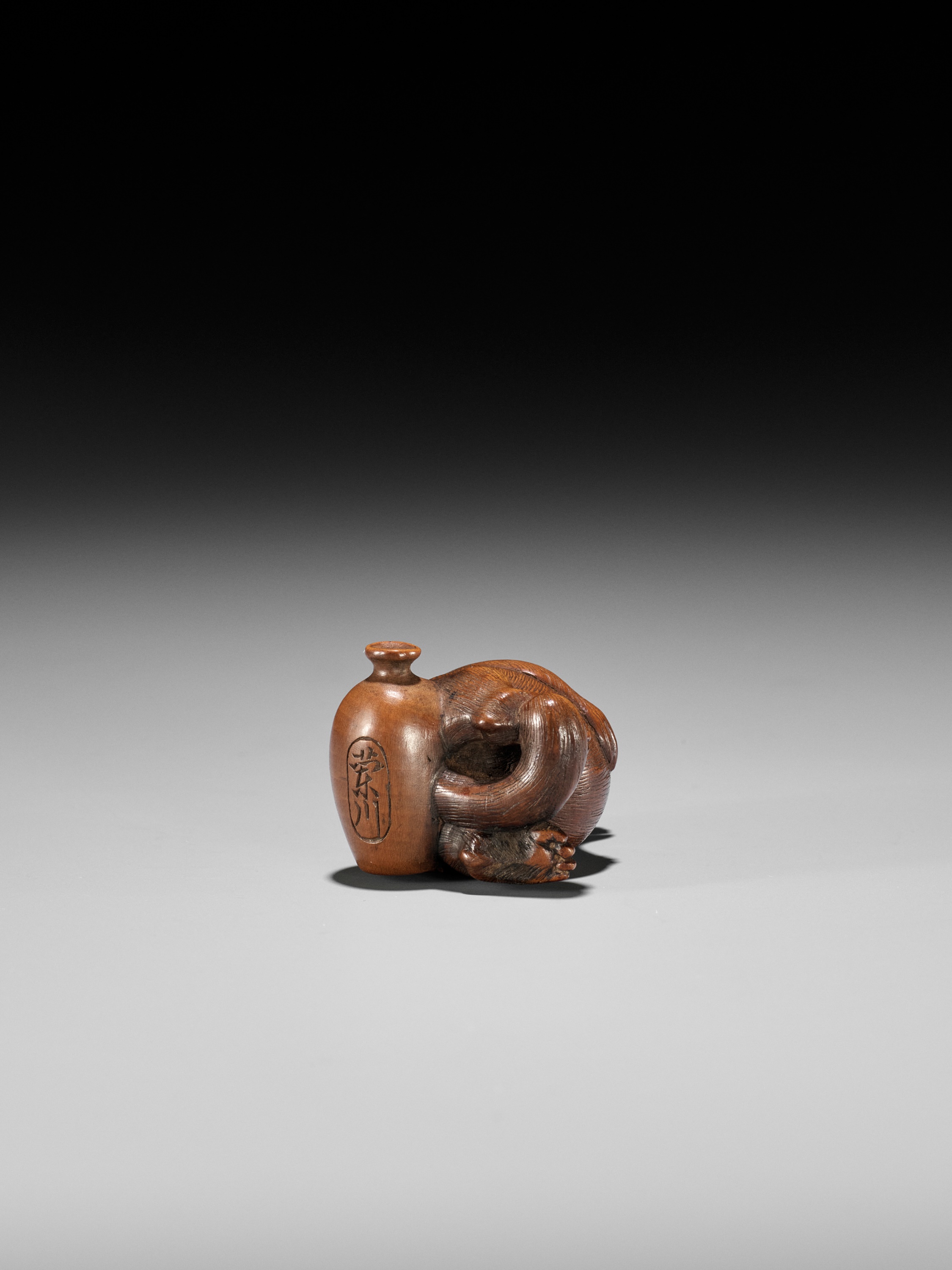 RANSEN: A FINE WOOD NETSUKE OF A DRUNKEN TANUKI HARA NO TSUZUMI - Image 13 of 14