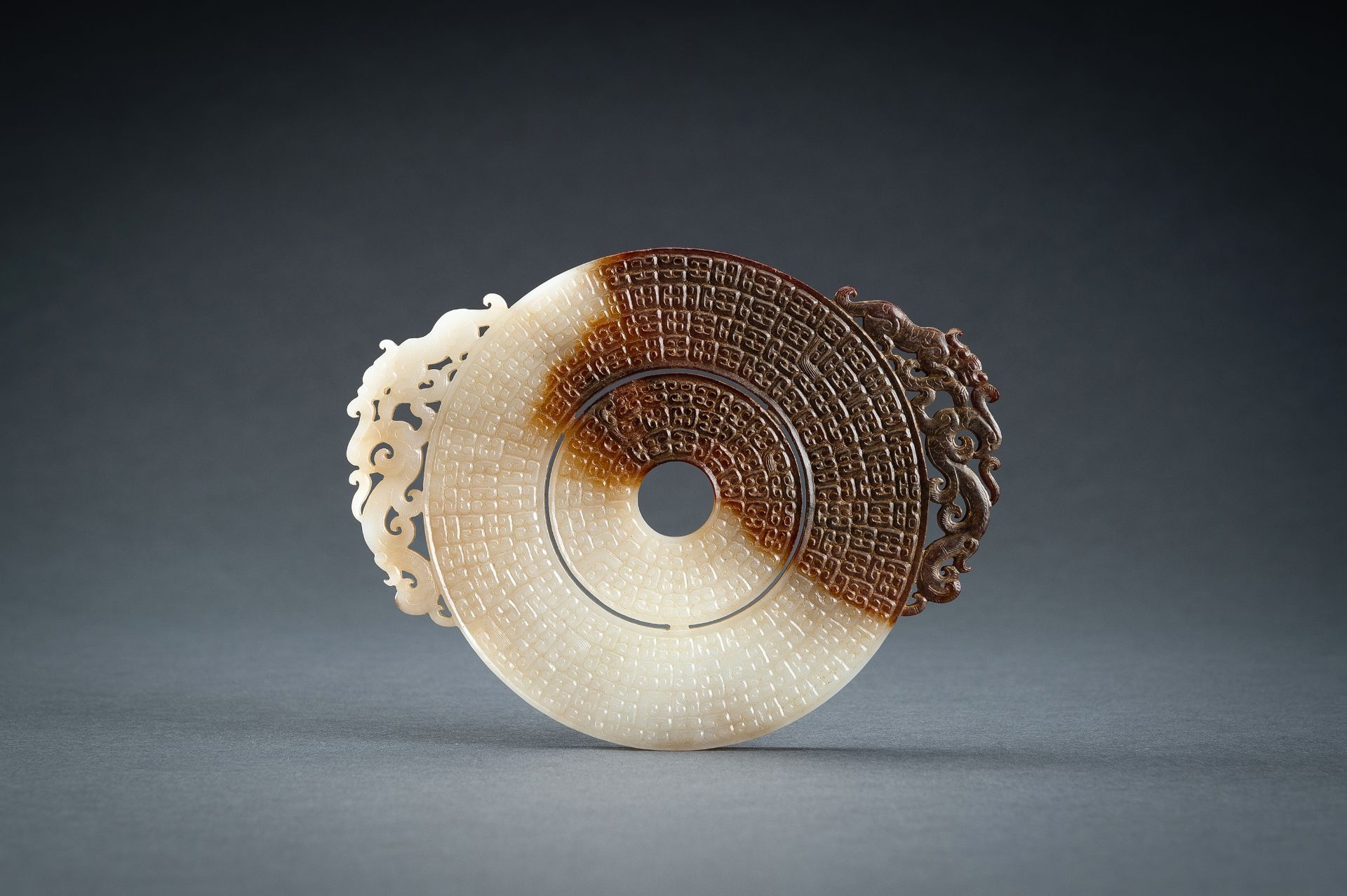 AN ARCHAISTIC WHITE AND BROWN JADE DOUBLE BI DISC, QING - Image 3 of 15