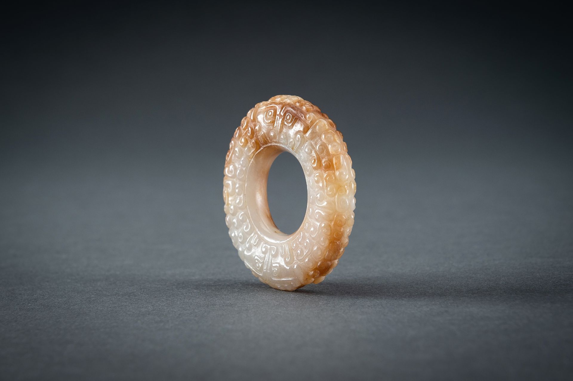 A WHITE AND RUSSET JADE 'CURLS AND TAOTIE MASKS' RING, HUAN, QING - Image 10 of 19