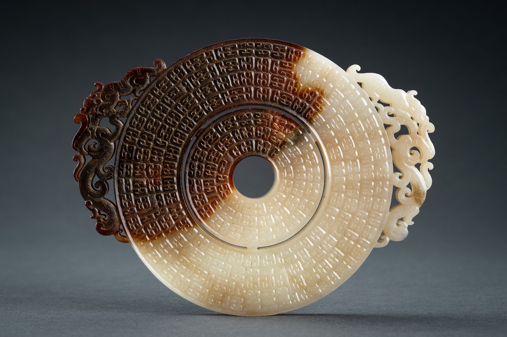 AN ARCHAISTIC WHITE AND BROWN JADE DOUBLE BI DISC, QING - Image 12 of 15