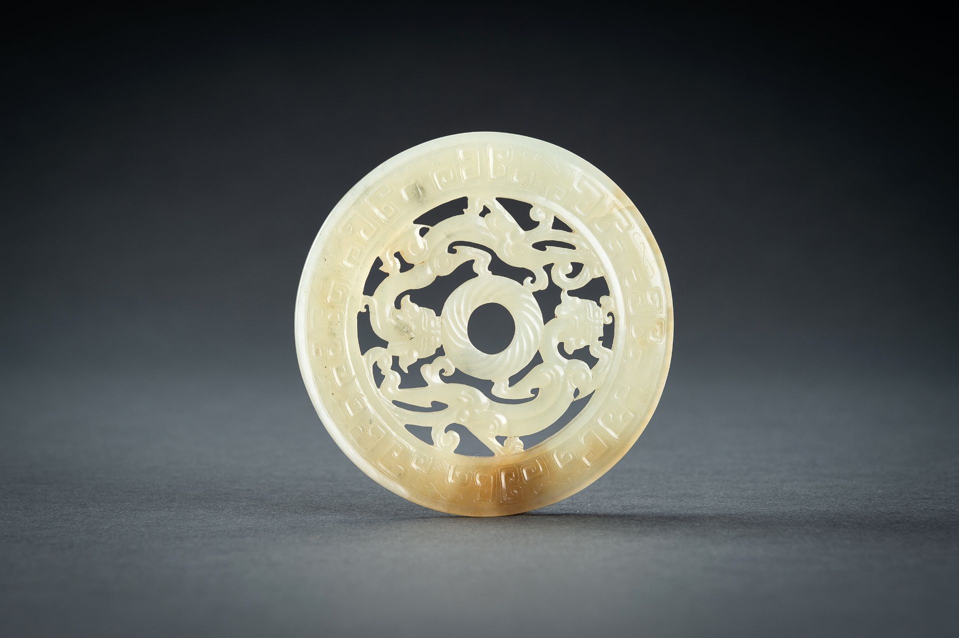 AN ARCHAISTIC YELLOW JADE RETICULATED 'CHILONG' BI DISC, QING - Image 2 of 15