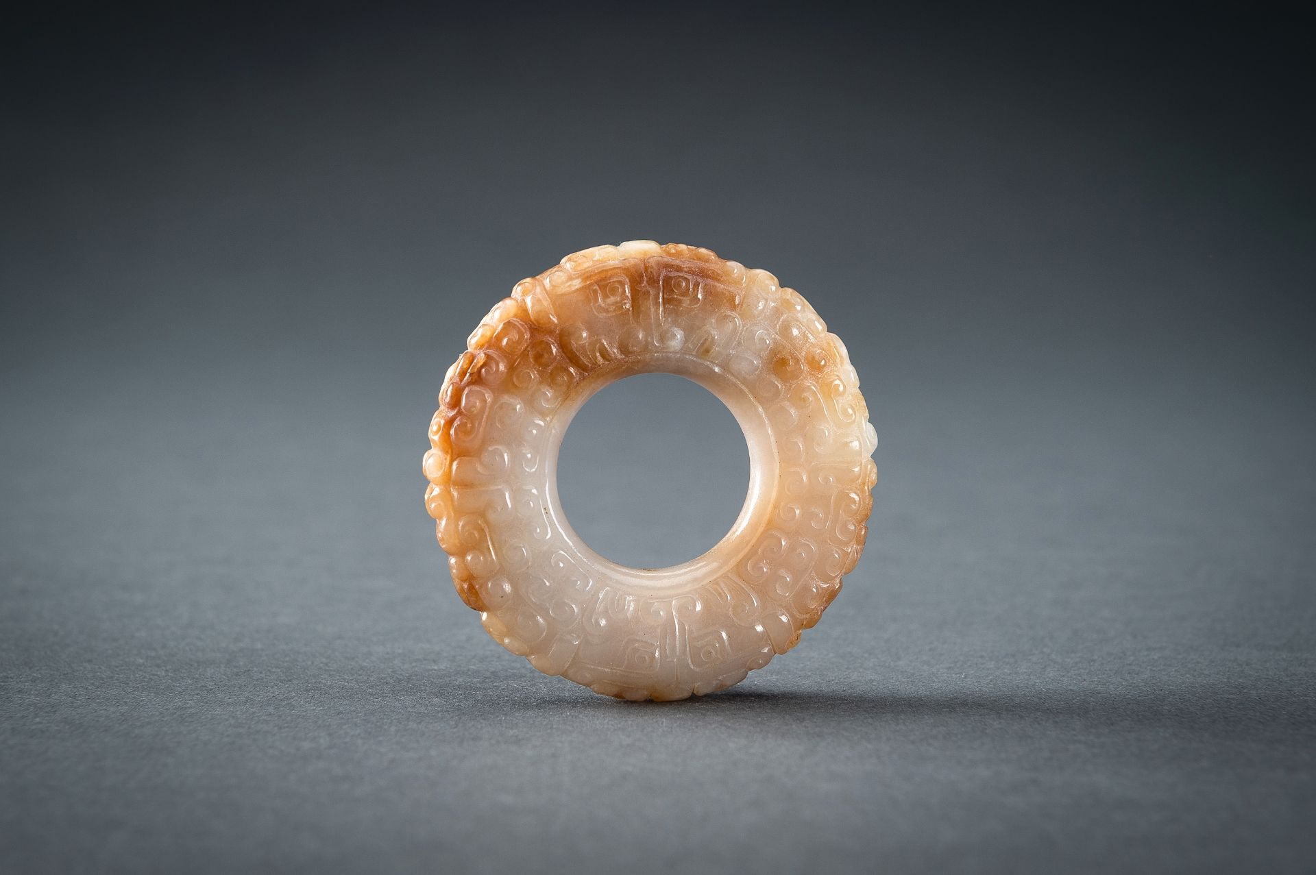 A WHITE AND RUSSET JADE 'CURLS AND TAOTIE MASKS' RING, HUAN, QING - Image 16 of 19
