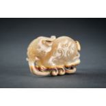 AN ARCHAISTIC PALE CELADON JADE PENDANT OF A QILIN, QING