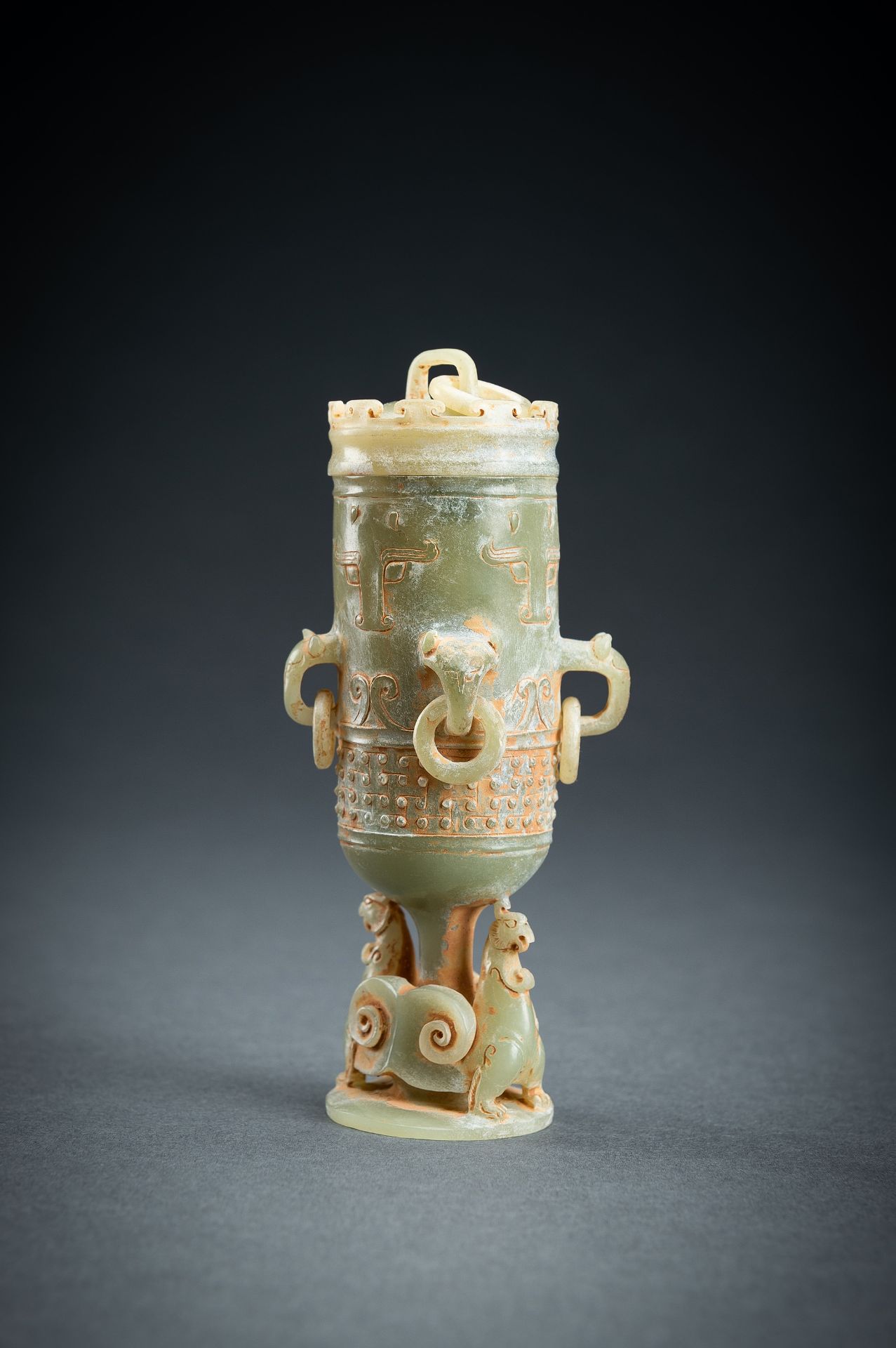 A SMALL ARCHAISTIC CELADON JADE VASE AND COVER