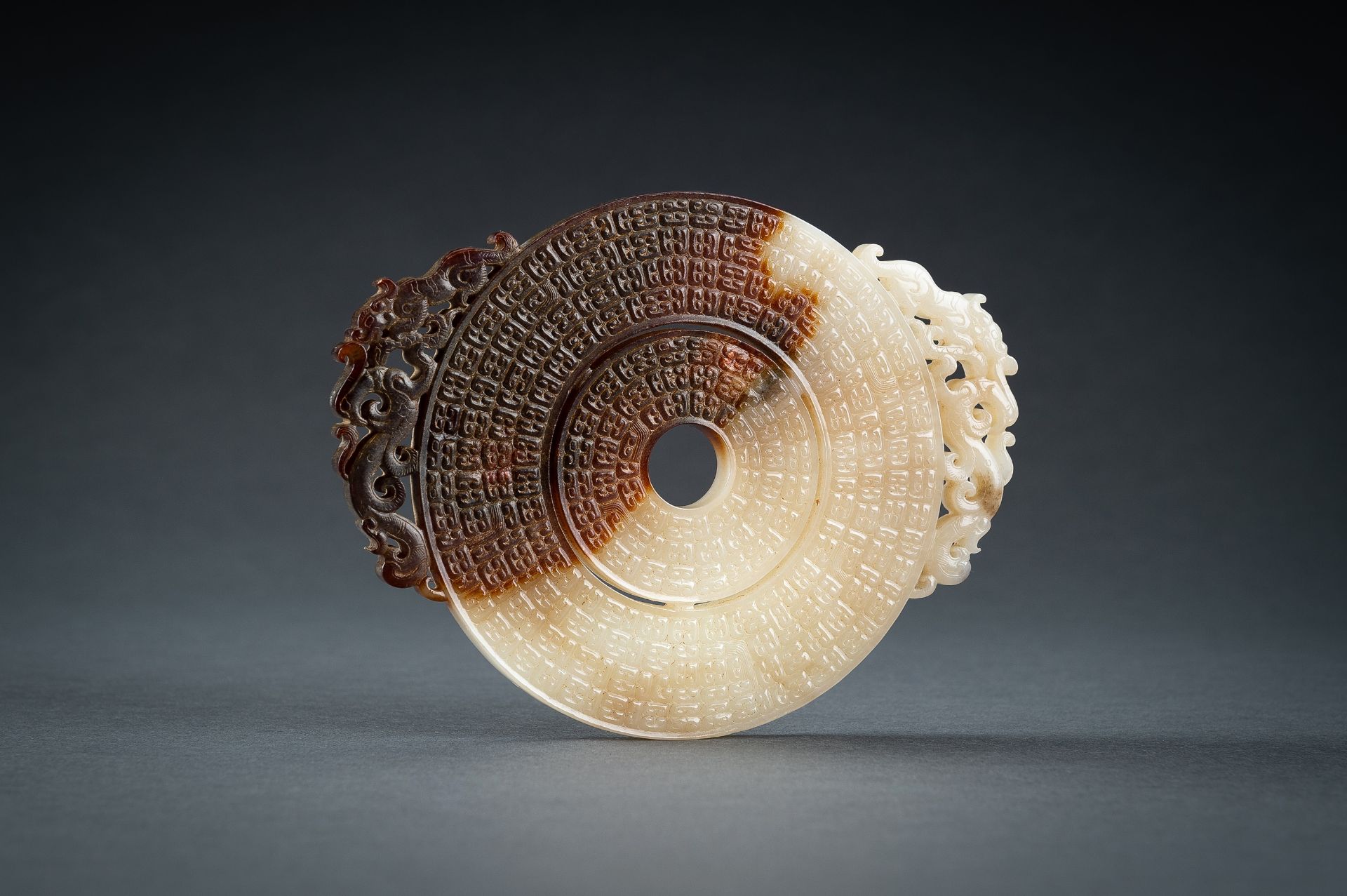 AN ARCHAISTIC WHITE AND BROWN JADE DOUBLE BI DISC, QING - Image 6 of 15