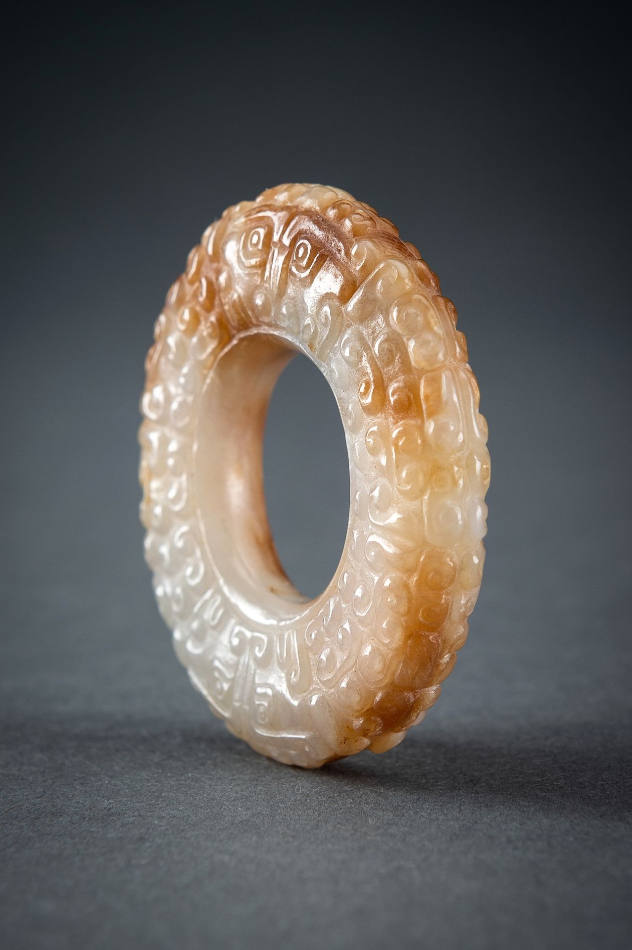 A WHITE AND RUSSET JADE 'CURLS AND TAOTIE MASKS' RING, HUAN, QING - Image 11 of 19