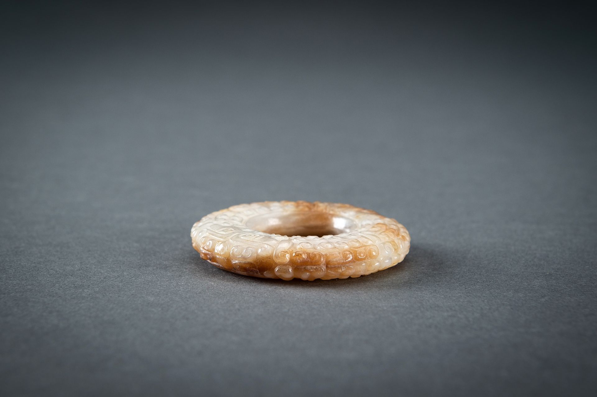 A WHITE AND RUSSET JADE 'CURLS AND TAOTIE MASKS' RING, HUAN, QING - Image 17 of 19