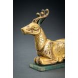 AN ARCHAISTIC FIRE-GILT COPPER REPOUSSÃ‰ FIGURE OF A DEER