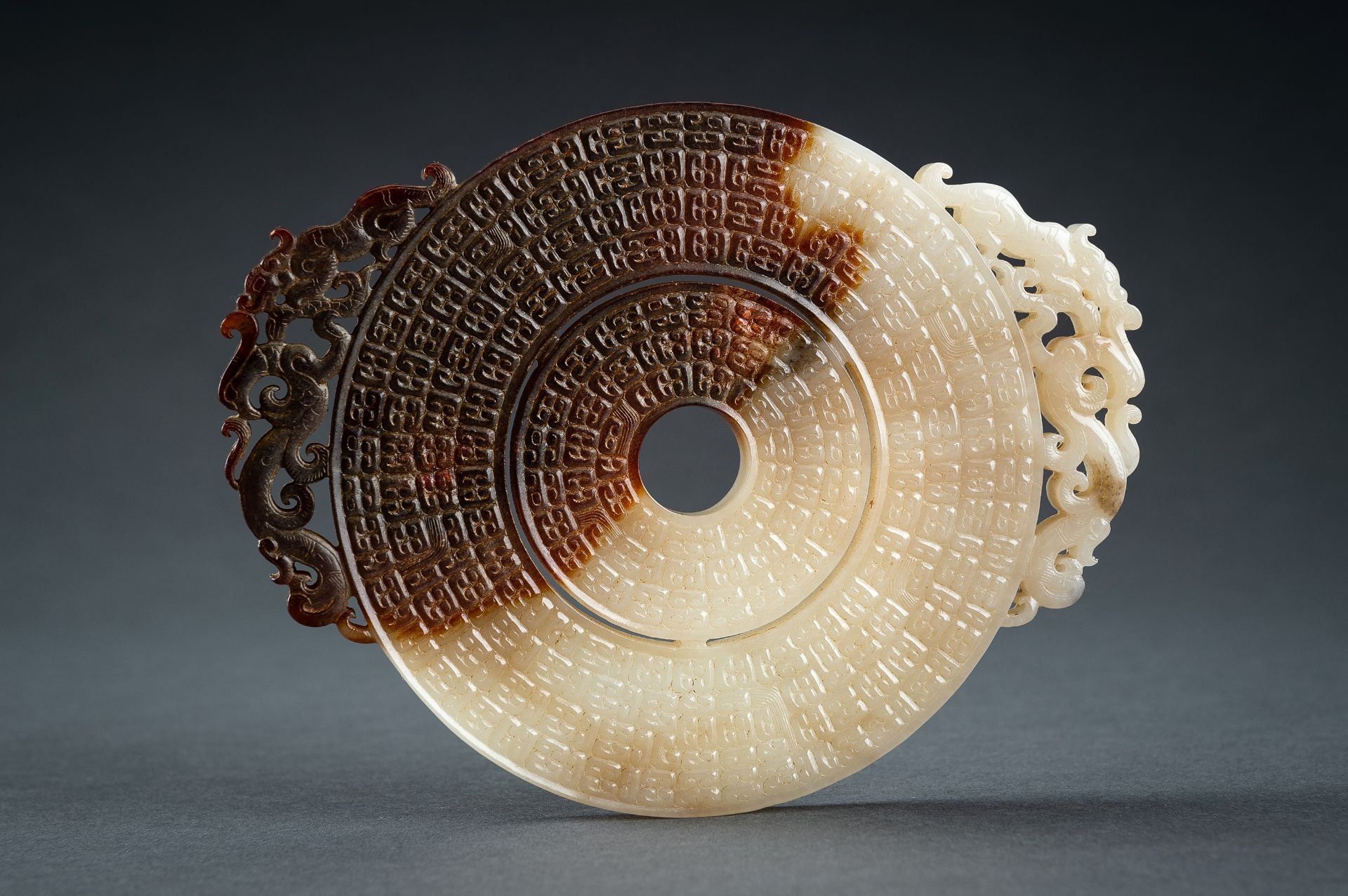 AN ARCHAISTIC WHITE AND BROWN JADE DOUBLE BI DISC, QING - Image 8 of 15