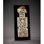 A FINE OPENWORK WHITE AND RUSSET JADE PLAQUE WITH THE ANIMALS OF THE FOUR DIRECTIONS, QING