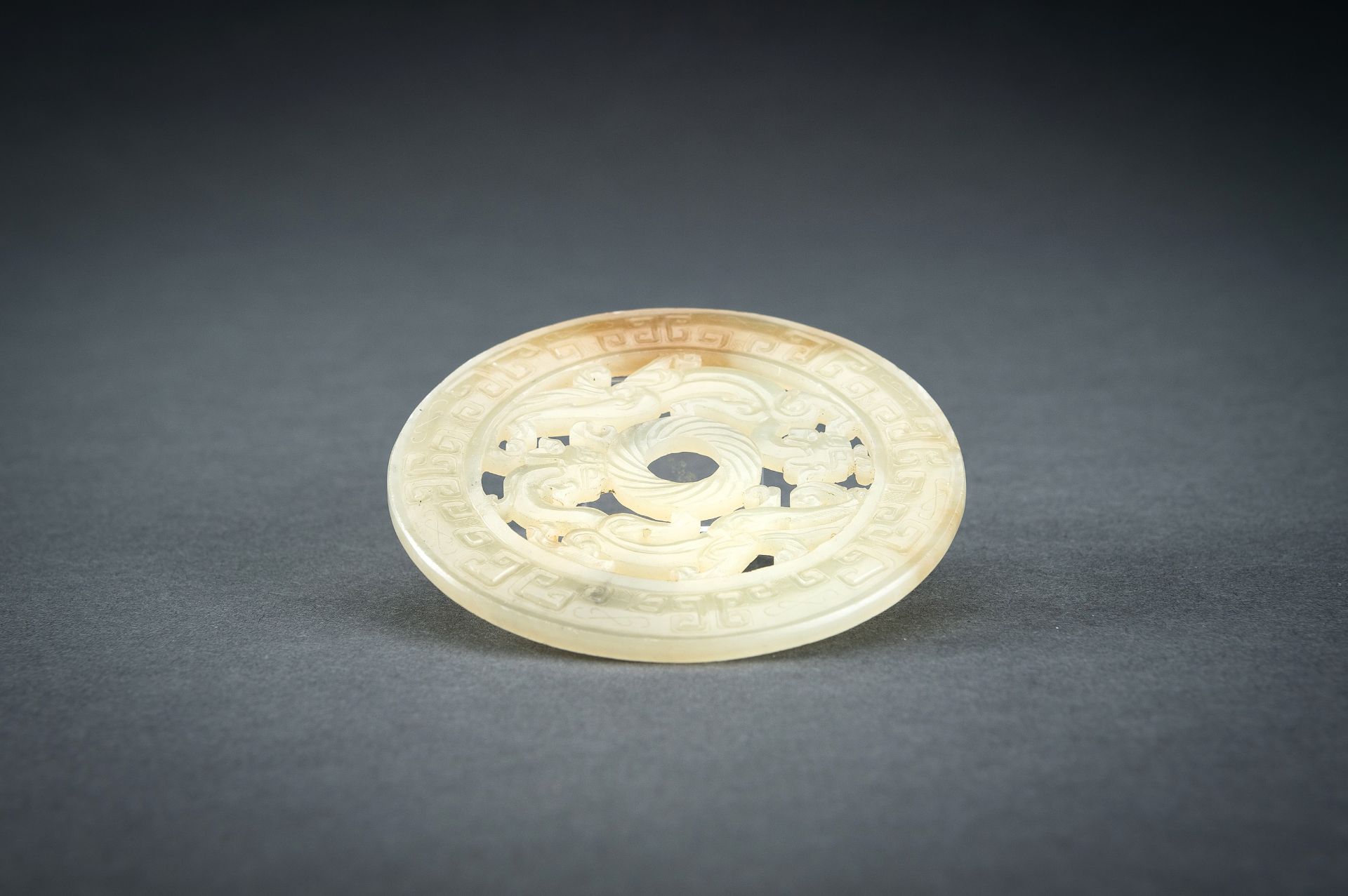 AN ARCHAISTIC YELLOW JADE RETICULATED 'CHILONG' BI DISC, QING - Image 14 of 15