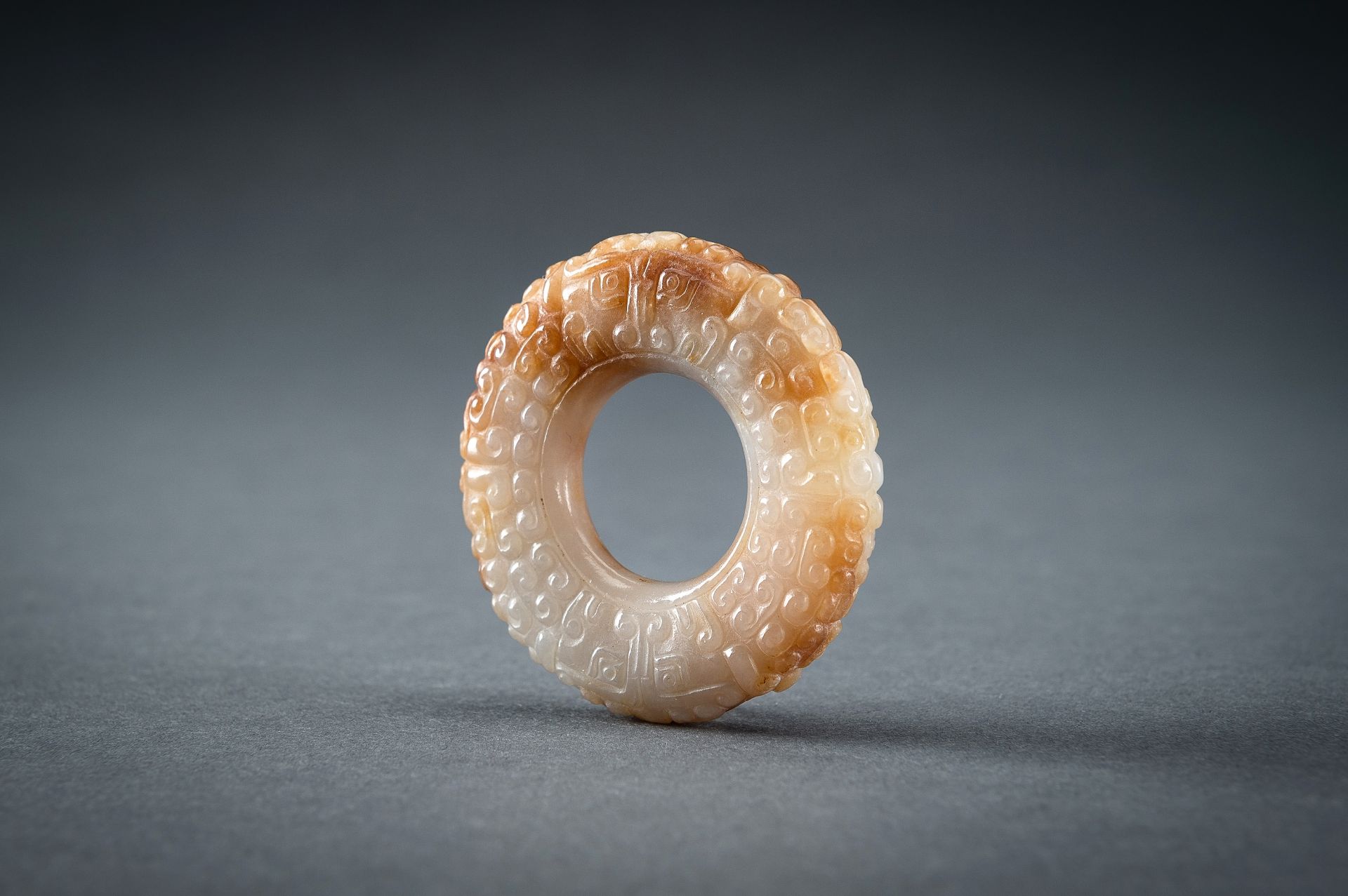 A WHITE AND RUSSET JADE 'CURLS AND TAOTIE MASKS' RING, HUAN, QING - Image 12 of 19