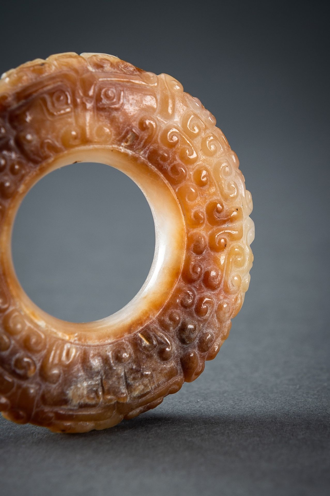 A WHITE AND RUSSET JADE 'CURLS AND TAOTIE MASKS' RING, HUAN, QING - Image 4 of 19
