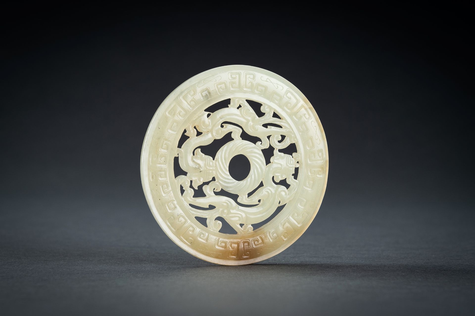 AN ARCHAISTIC YELLOW JADE RETICULATED 'CHILONG' BI DISC, QING - Image 9 of 15
