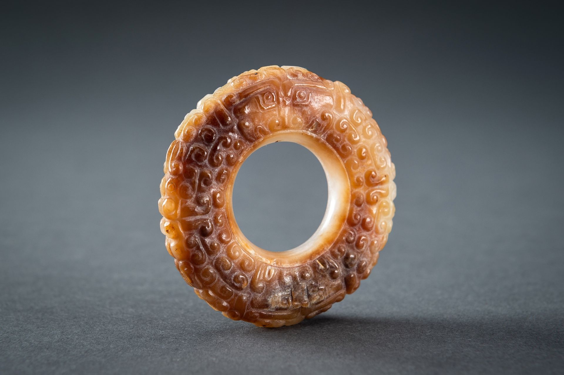 A WHITE AND RUSSET JADE 'CURLS AND TAOTIE MASKS' RING, HUAN, QING - Image 6 of 19